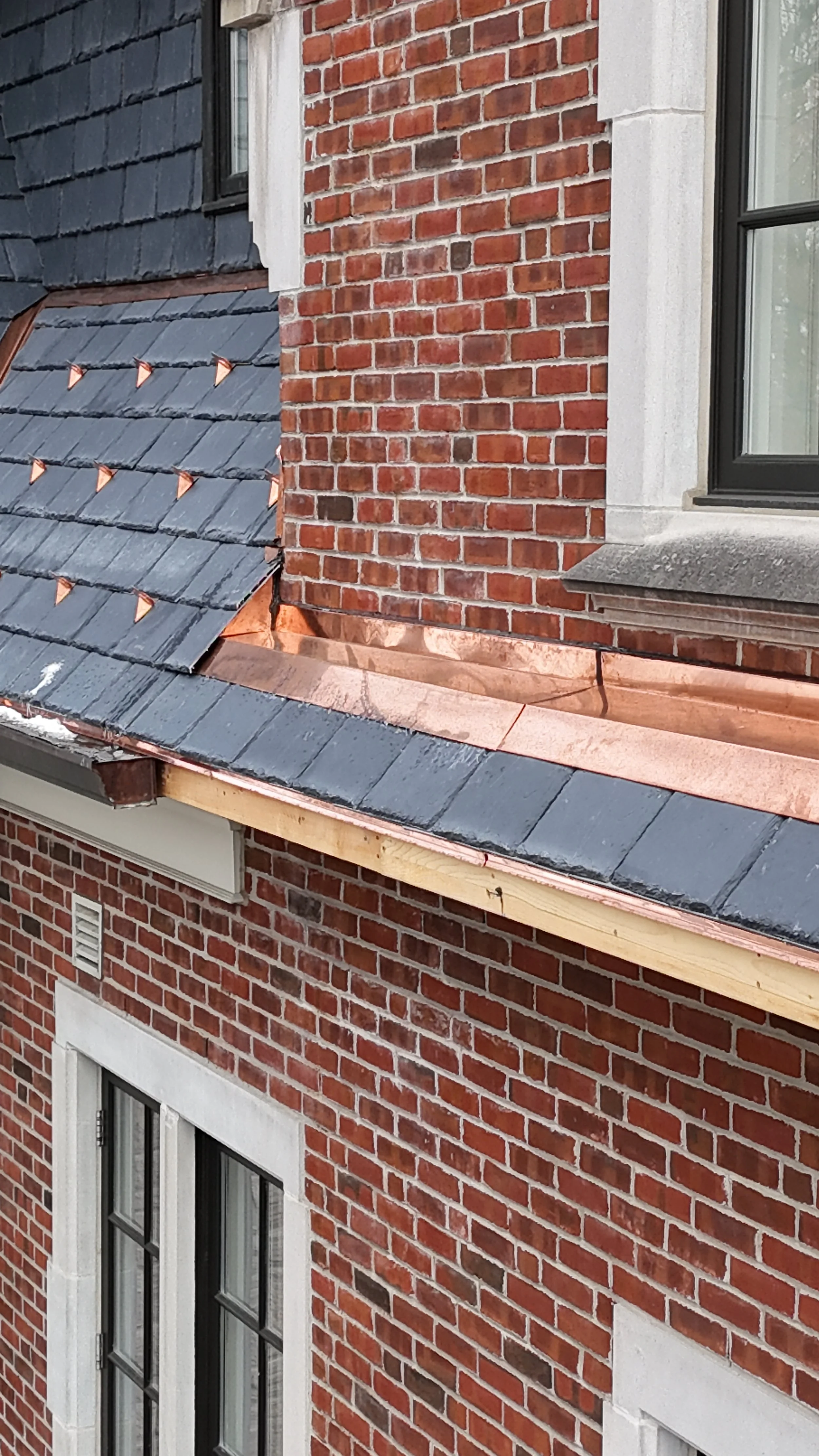 Custom copper standing seam roof and flashing on architectural structure overlooking Ontario landscape