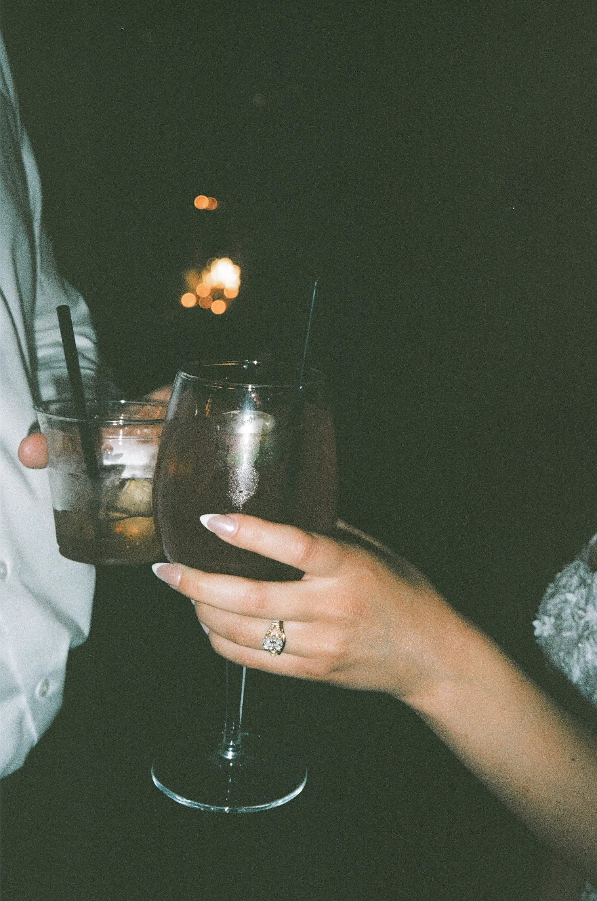 Bride and groom’s signature cocktail photographed with flash lighting at wedding reception captured on film