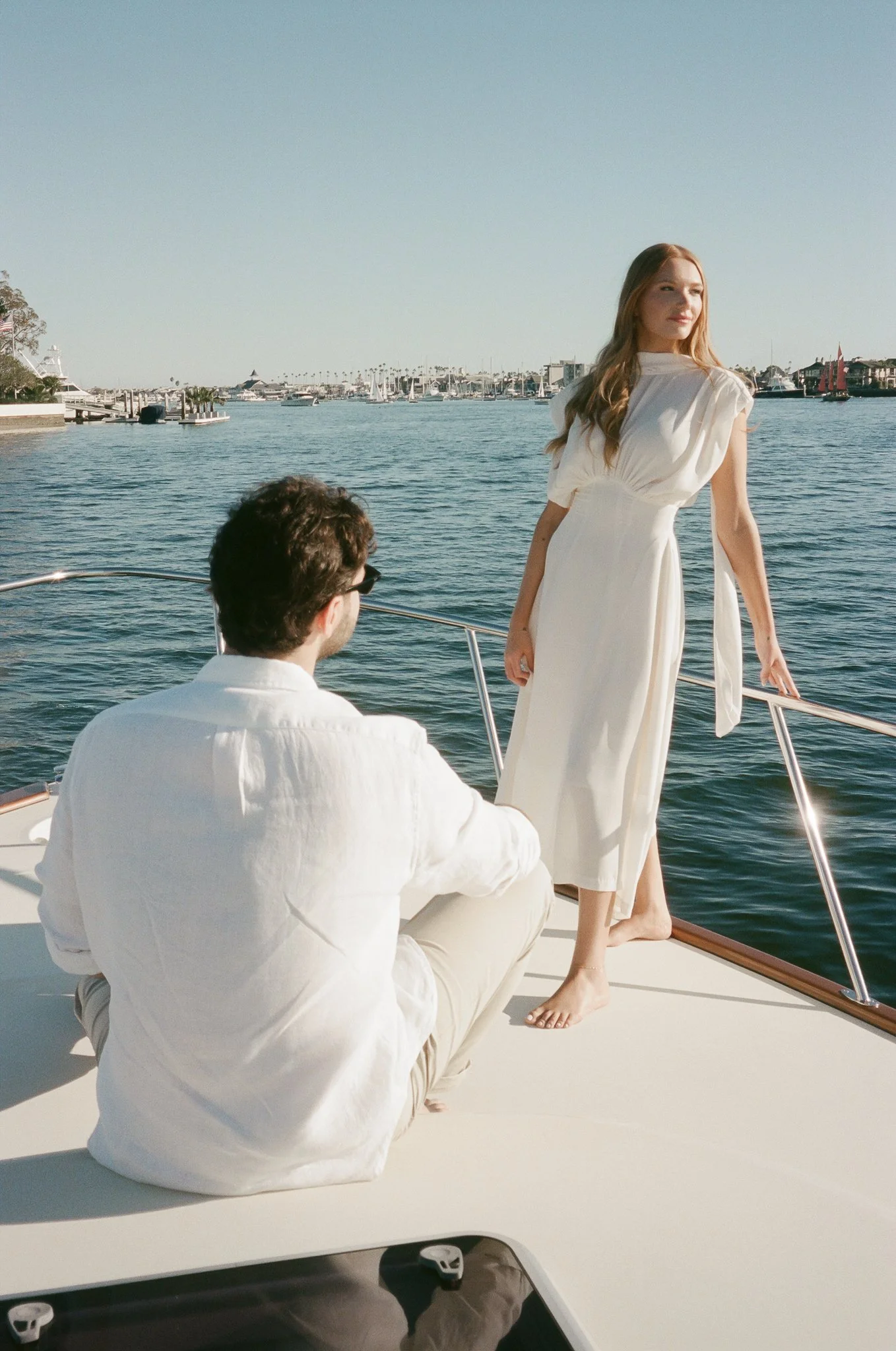 Newport Beach engagement photos on a boat with a timeless, film aesthetic
