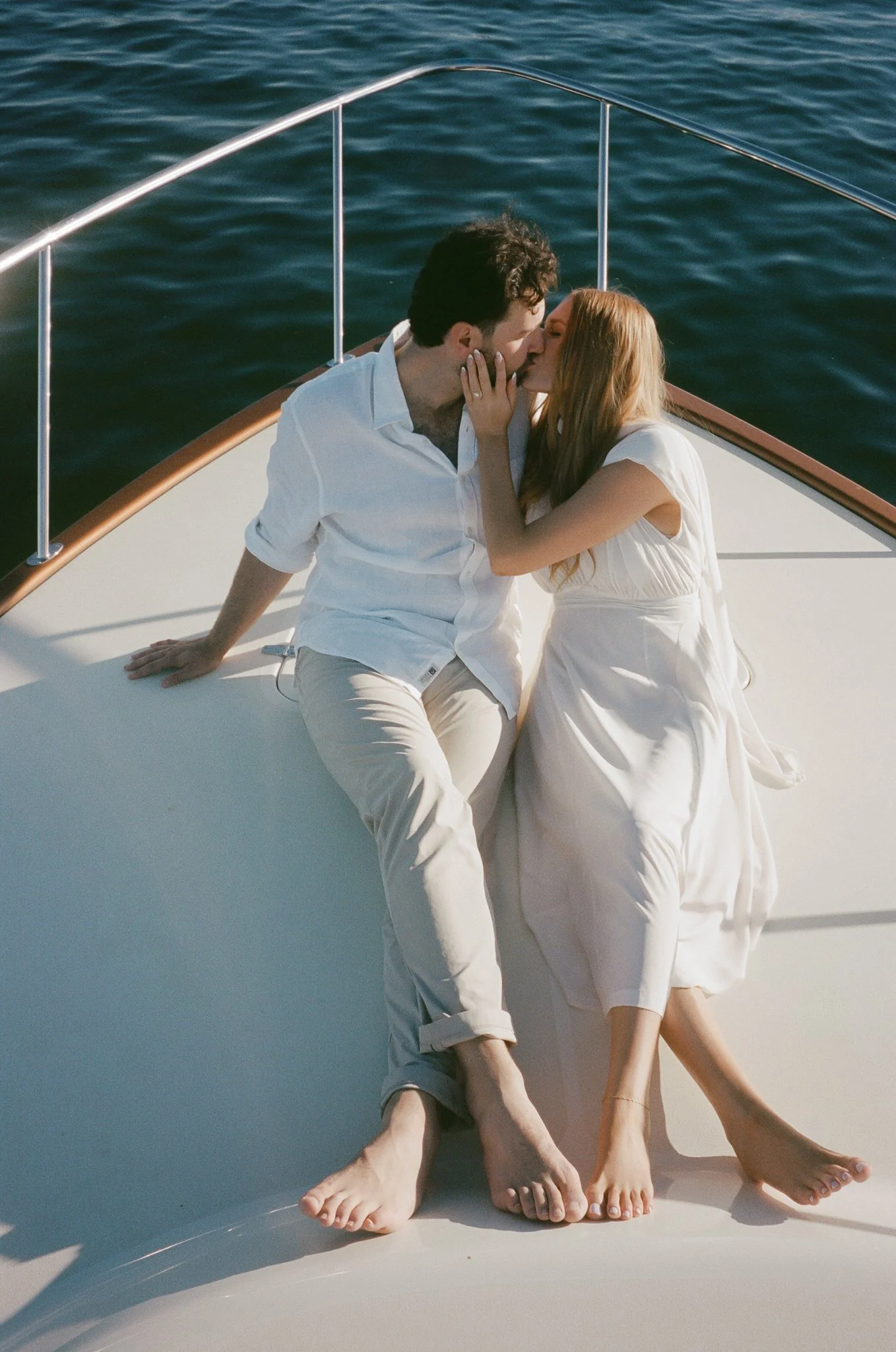 Newport Beach engagement photos on a boat with a timeless, film aesthetic