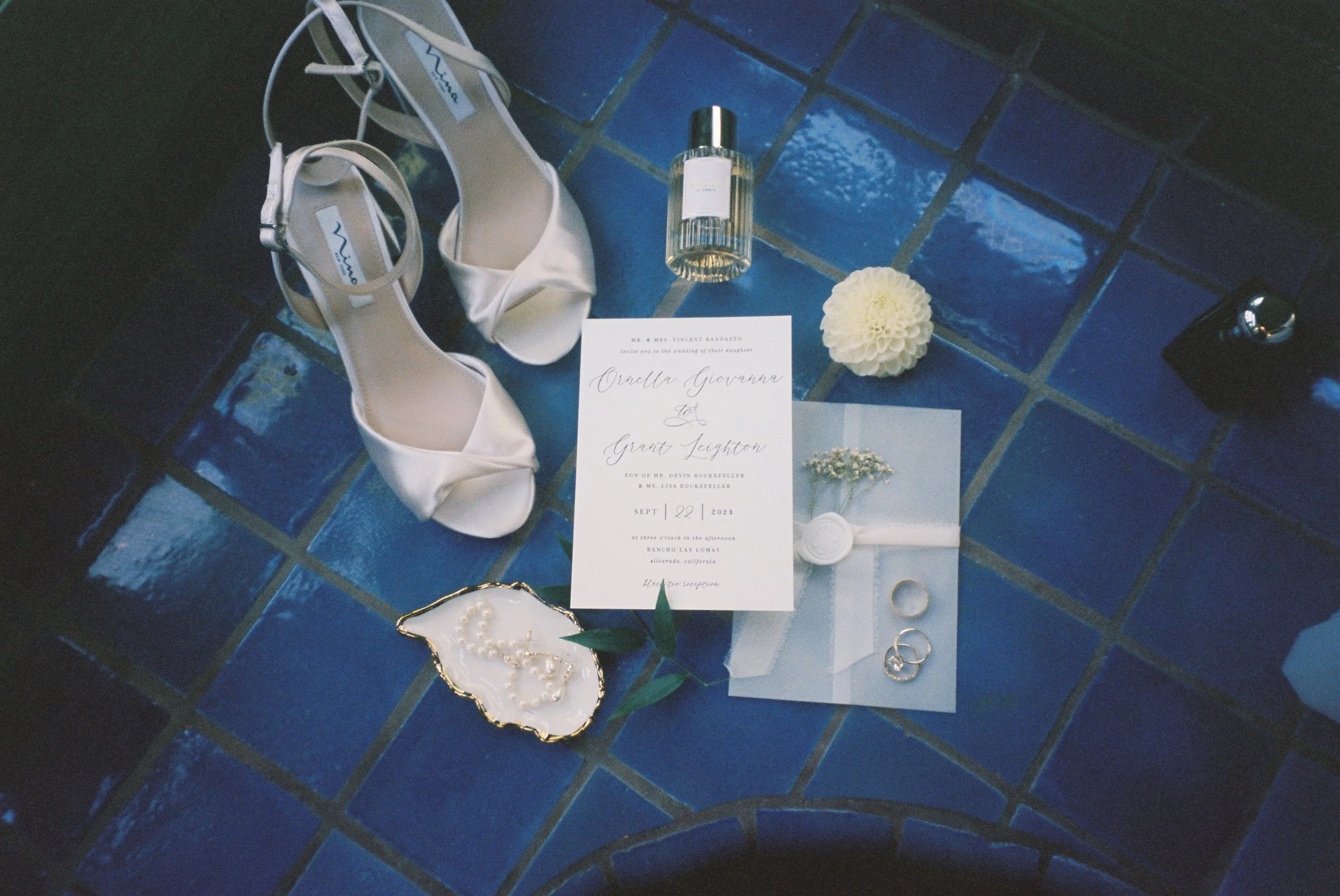 timeless wedding detail photo featuring shoes, jewelry, invitation, flowers, rings and shoes captured on film at Rancho Las Lomas by Jennifer Noelle