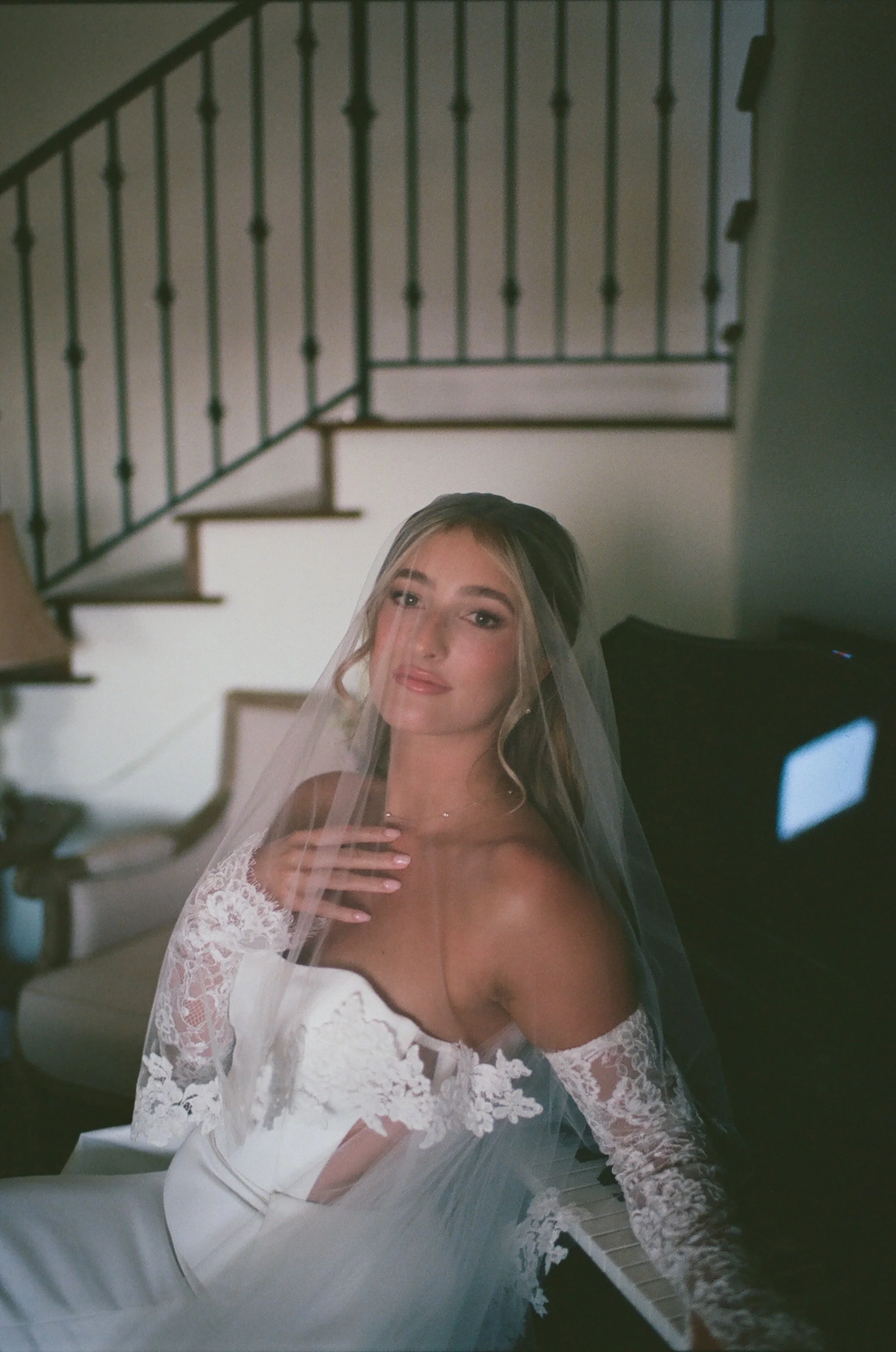 Timeless bridal portrait captured on film at Jeune Perché featuring the bride next to a piano