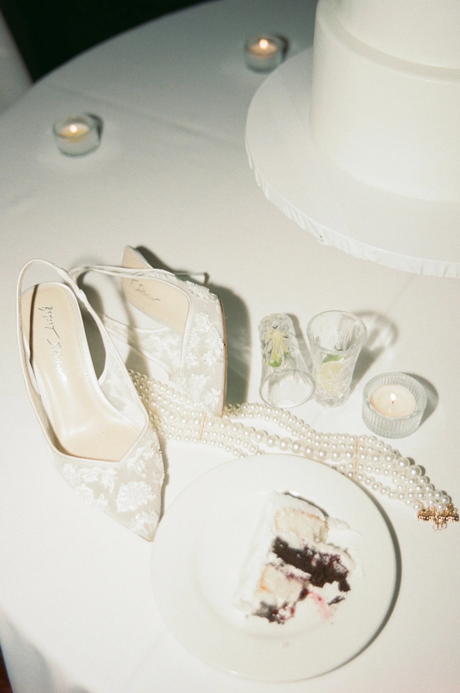 Modern flash wedding detail photo featuring shoes, jewelry, cake, and cocktails captured on film 