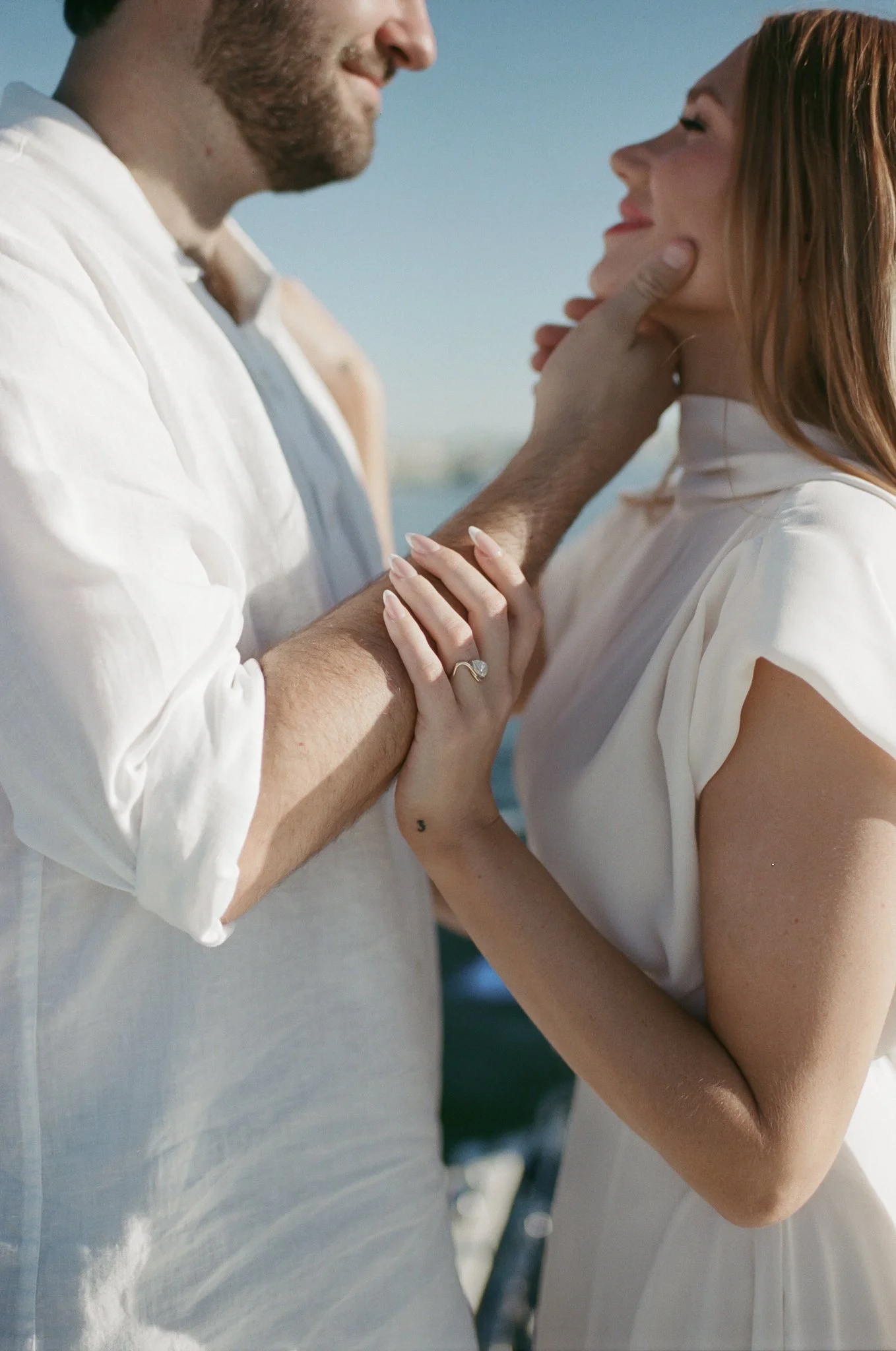Newport Beach engagement photos on a boat with a timeless, film aesthetic
