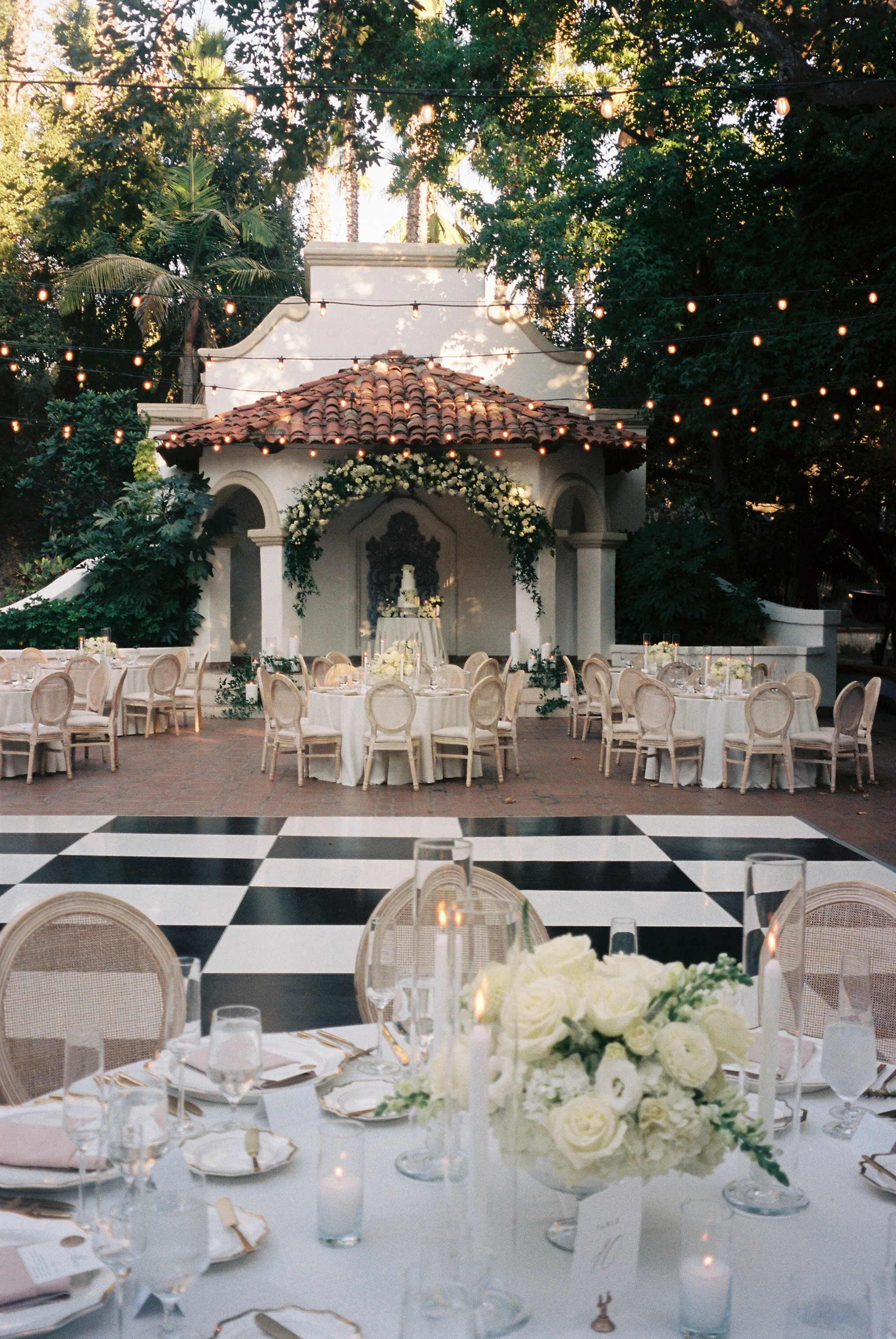 timeless wedding reception photo featuring tables, flowers, place settings on film at Rancho Las Lomas by Jennifer Noelle