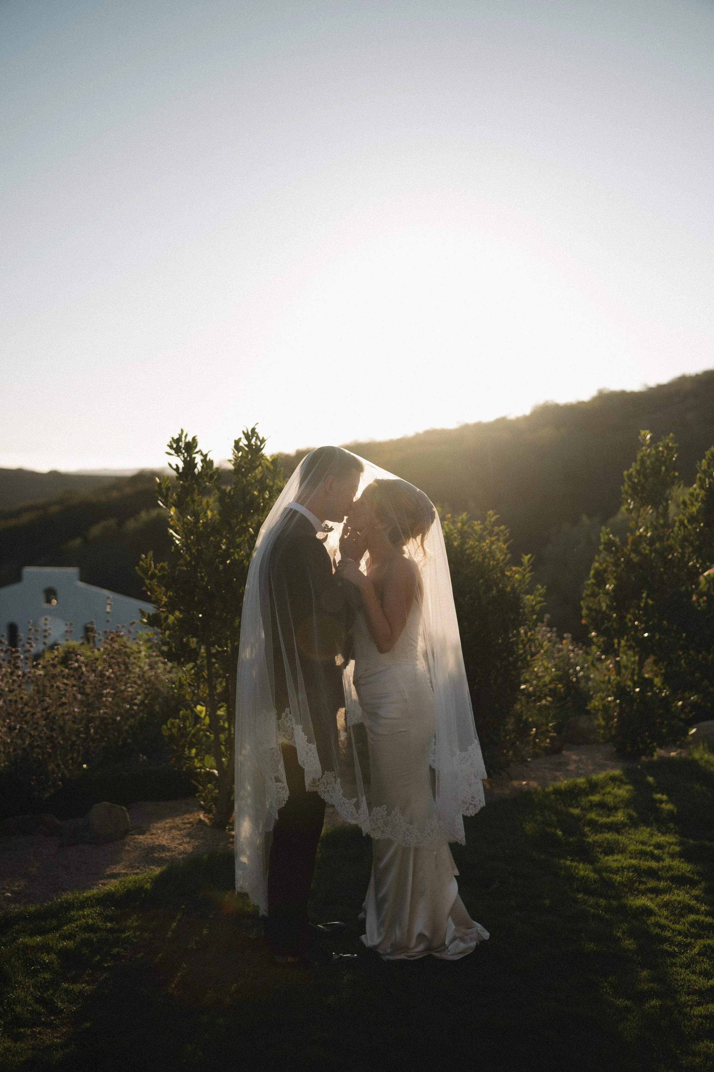 Romantic golden hour portrait of bride and groom at Jeune Perché in Oceanside, California by Jennifer Noelle