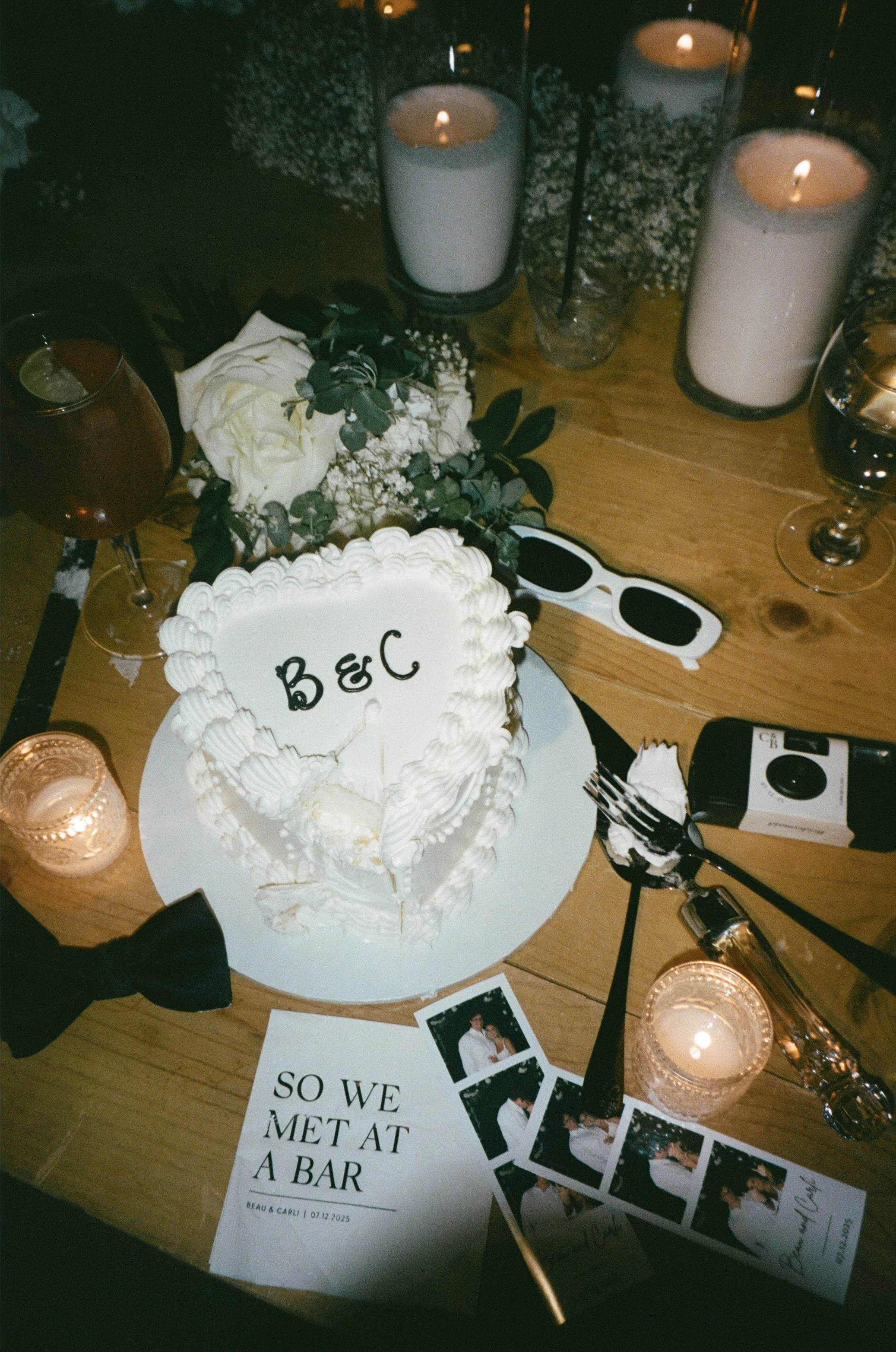 Reception table details photographed with flash lighting at wedding reception captured on film featuring wedding cake