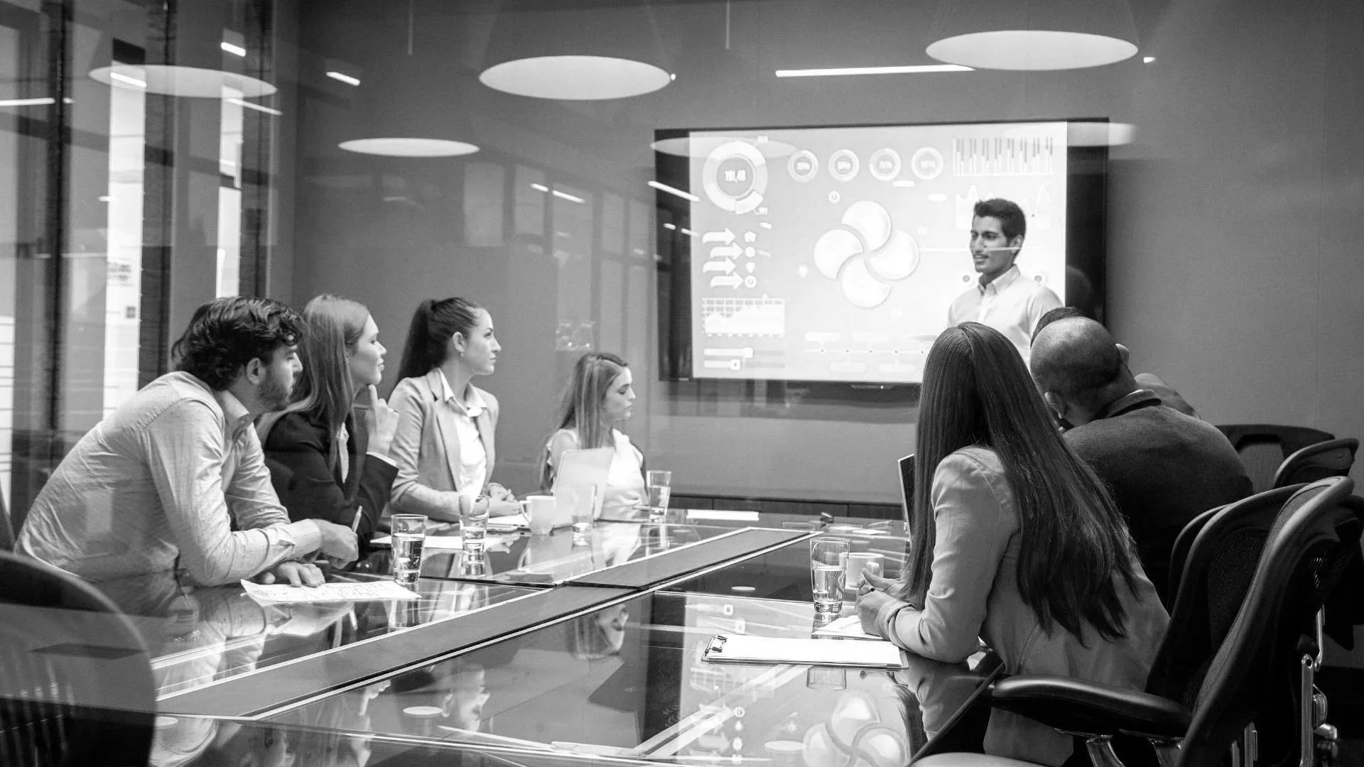 A presenter presenting in a board room