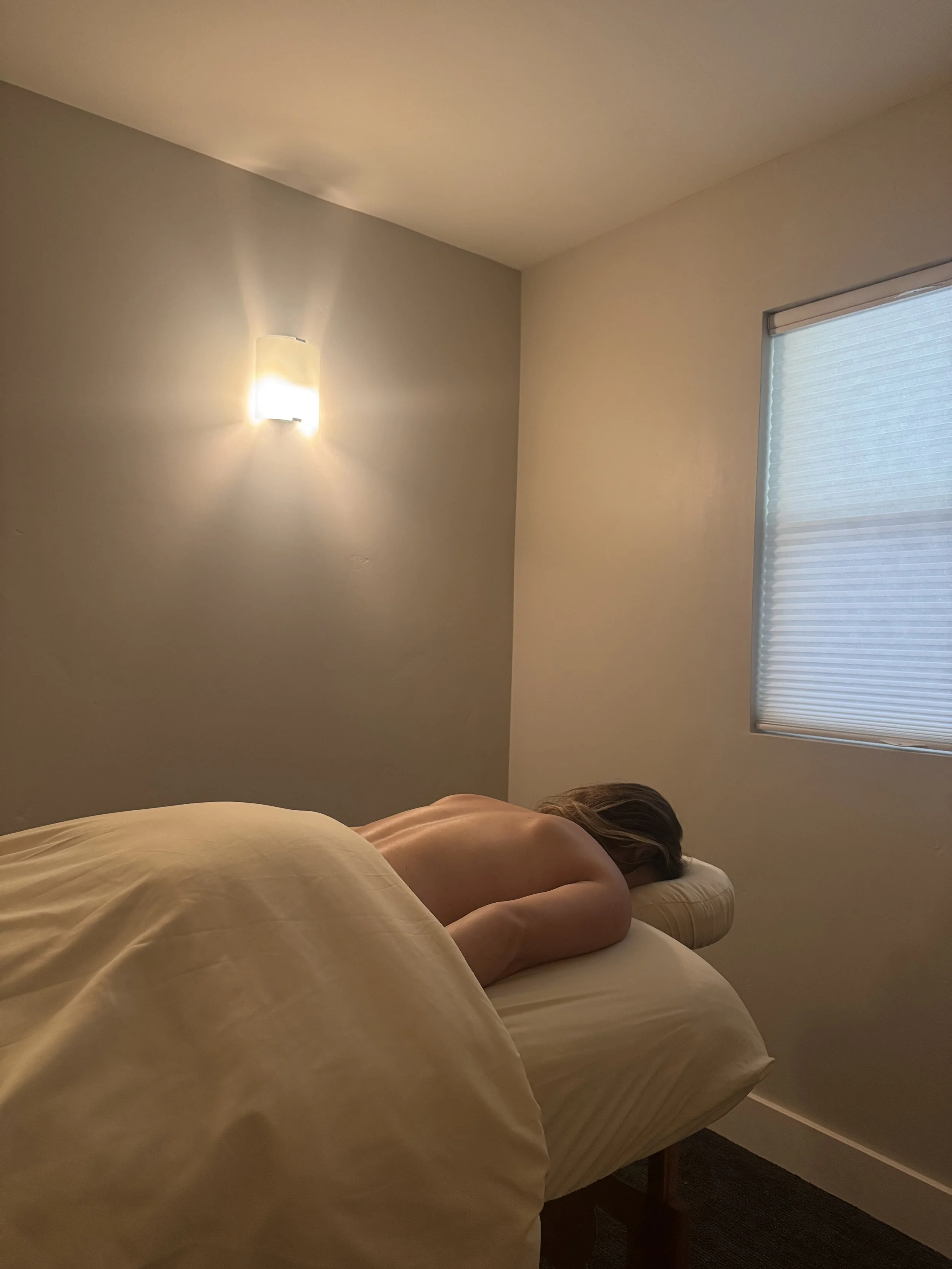 woman laying on a massage therapy table