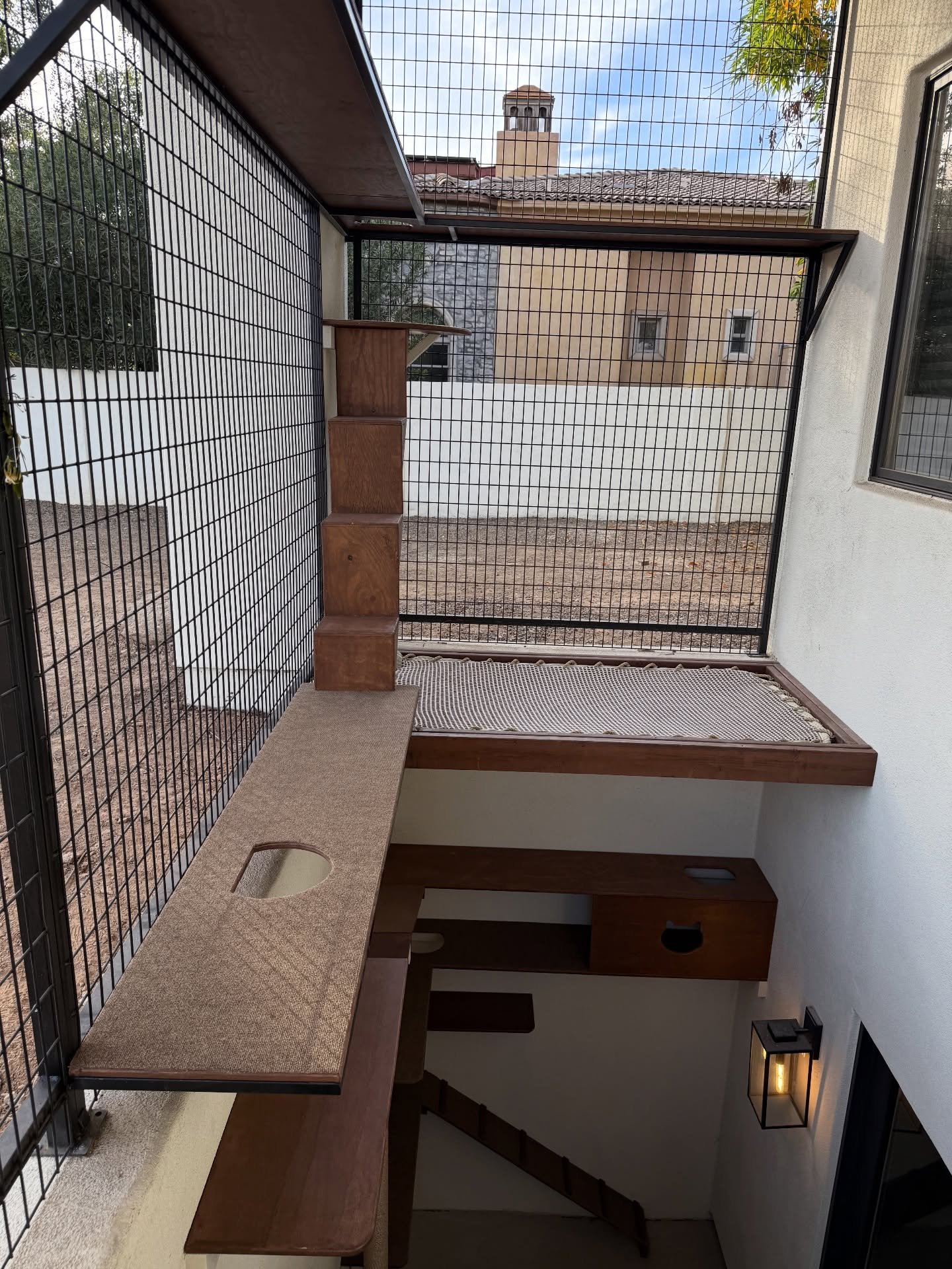 This basement patio was already enclosed, and we were ready to catify the space✨We added chocolate-stained shelves, a very tall cat pole, and a cat hammock to create the ultimate lounging space. Can&rsquo;t wait to see the kitties claim every inch of