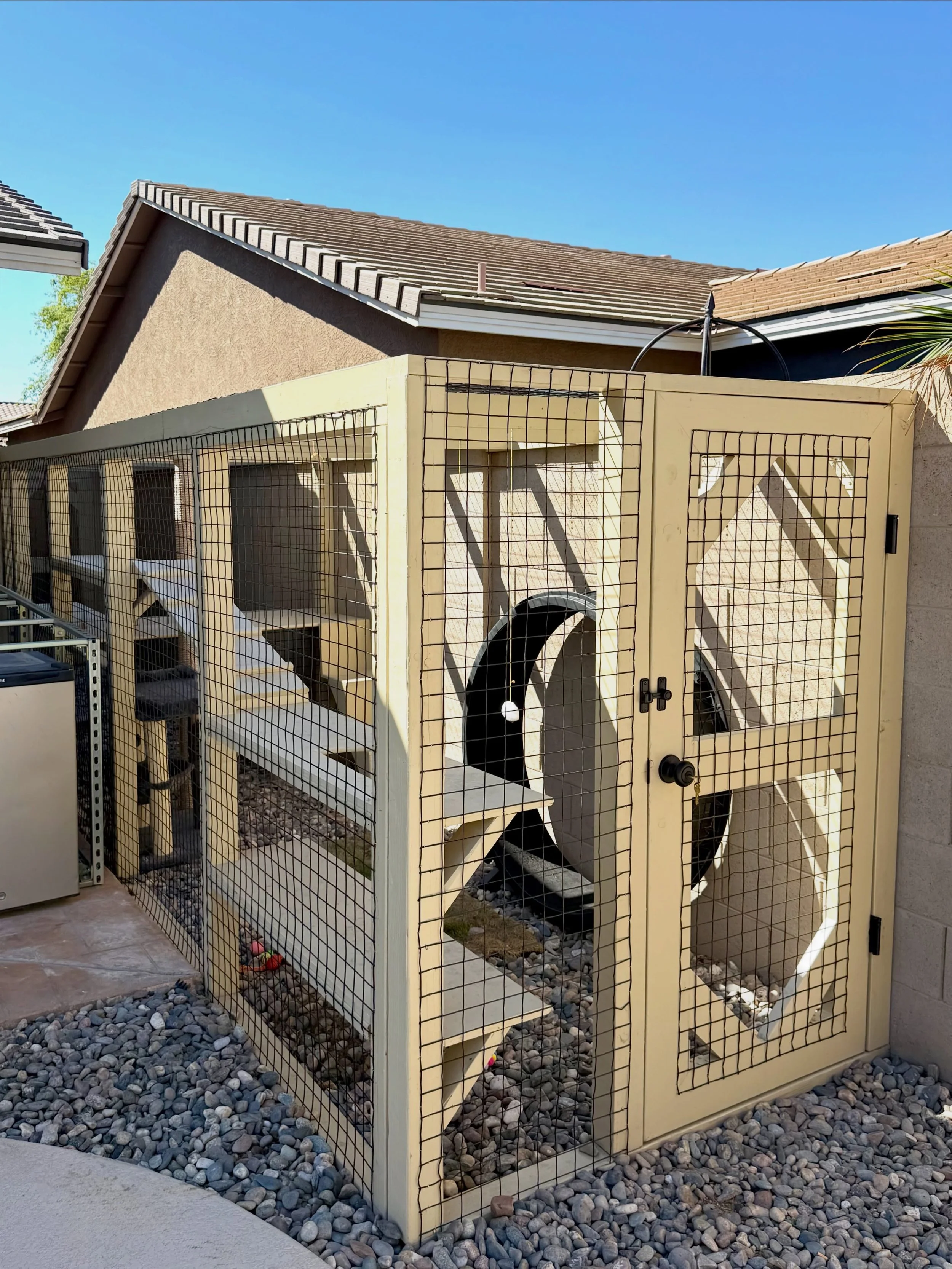 Sometimes a little separation is the key to getting along 😉

For this side-yard catio, we created a setup that lets the dogs use the area as their potty zone while giving the cats their own secure outdoor space. Both can use the same pet door, but t