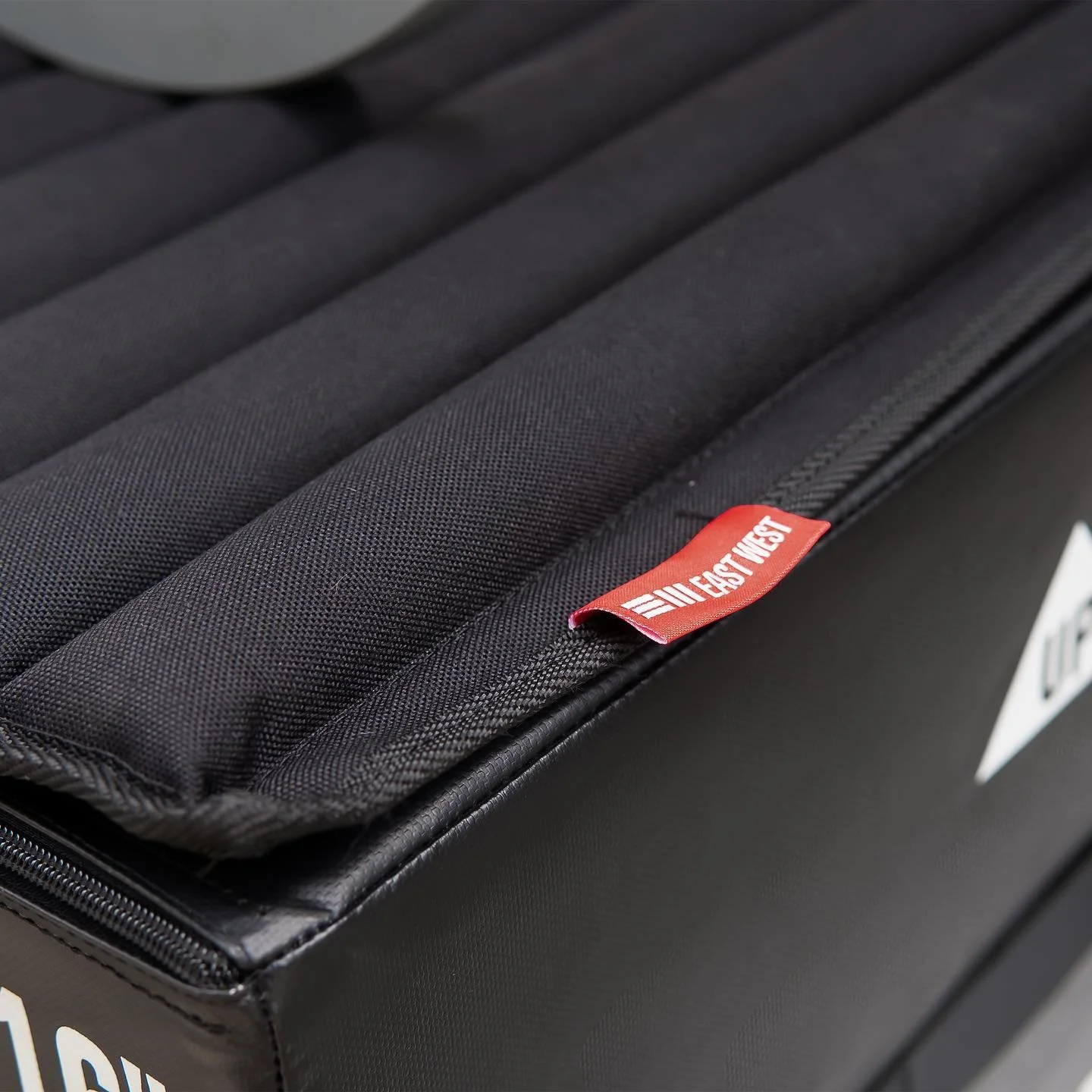 Close-up of a black carrying case with a red tab labeled 'The North Face' on top.