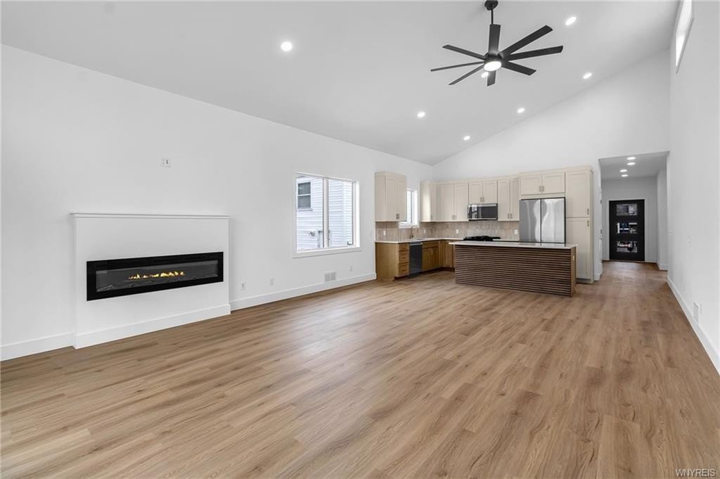 Modern living room with fireplace wood floors and large windows