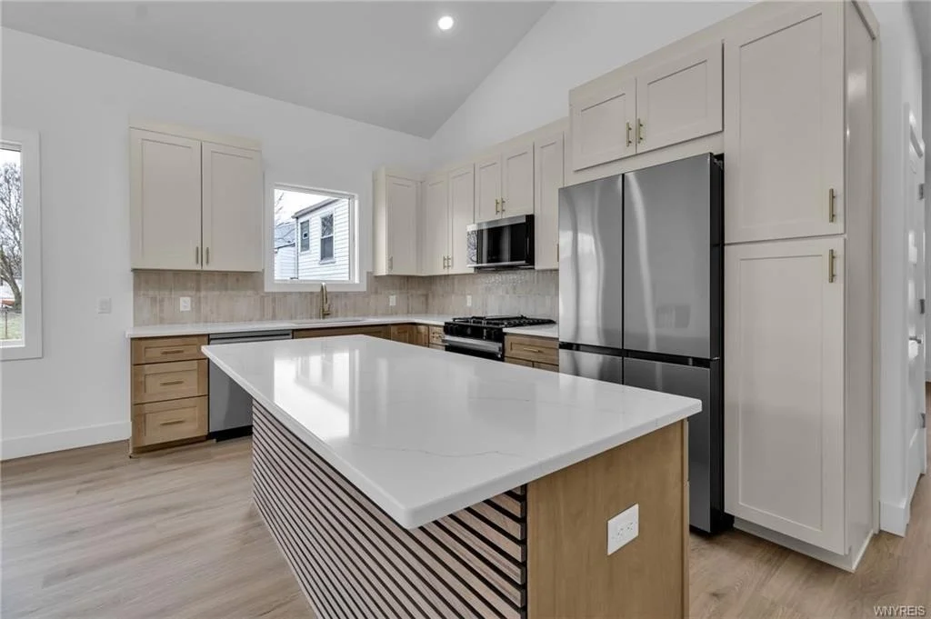 Modern two tone kitchen with antique white uppers and natural wood tone lowers