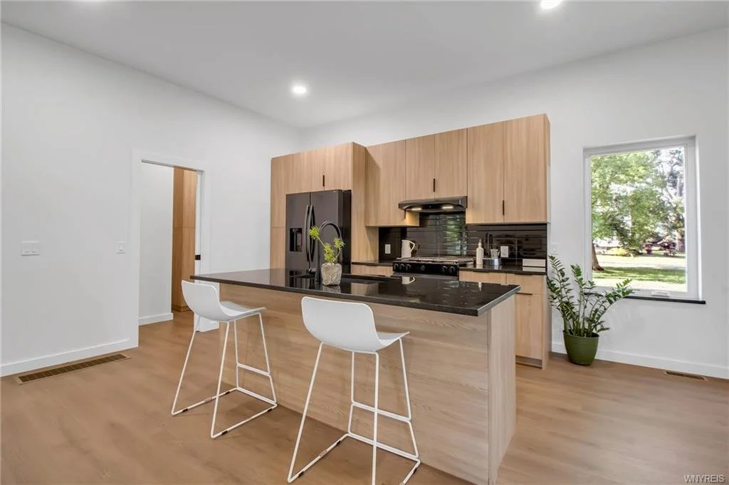 Modern kitchen, tan cabinets, black countertops