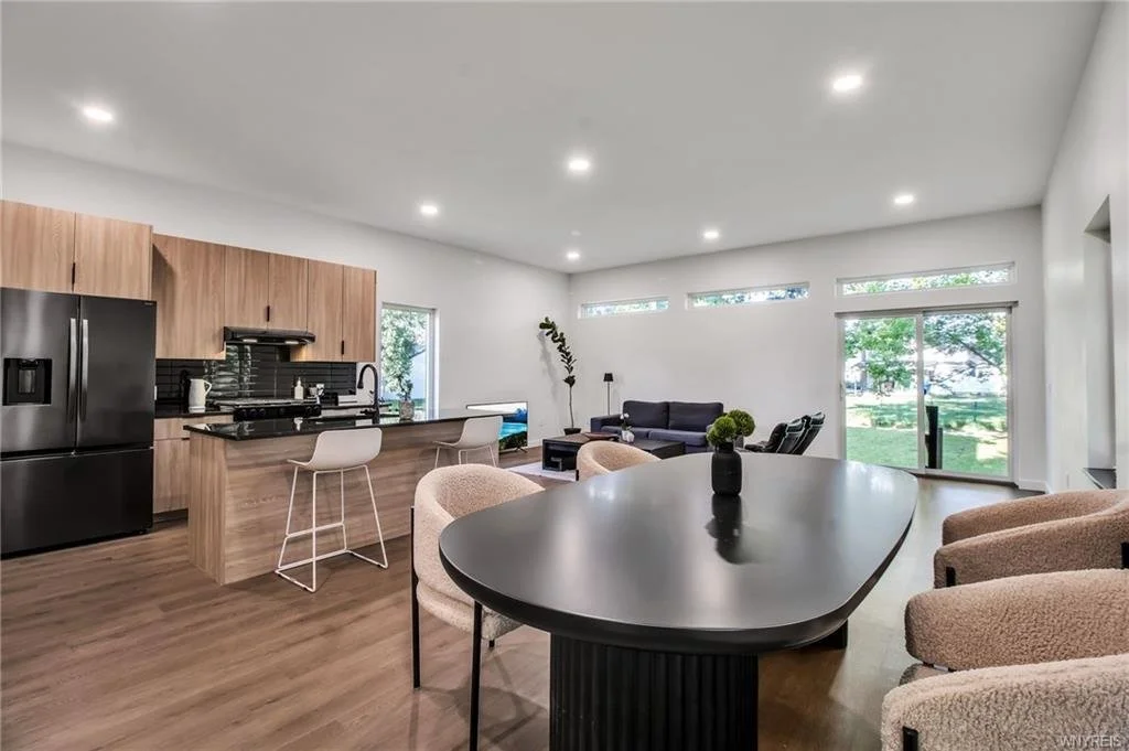 Black oval table, tan furniture, modern decor