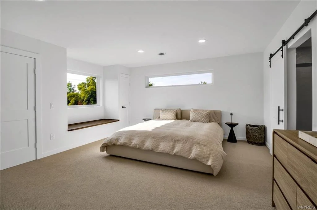 Modern decor, tan carpet, barn door, light and airy