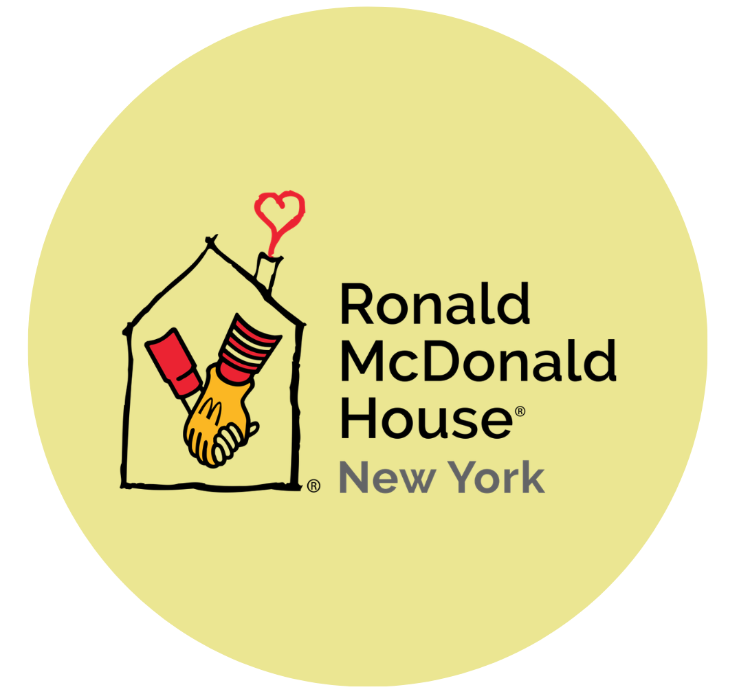 Logo of Ronald McDonald House New York featuring a house outline with two hands shaking inside, a heart-shaped chimney, and text with the organization's name and location.