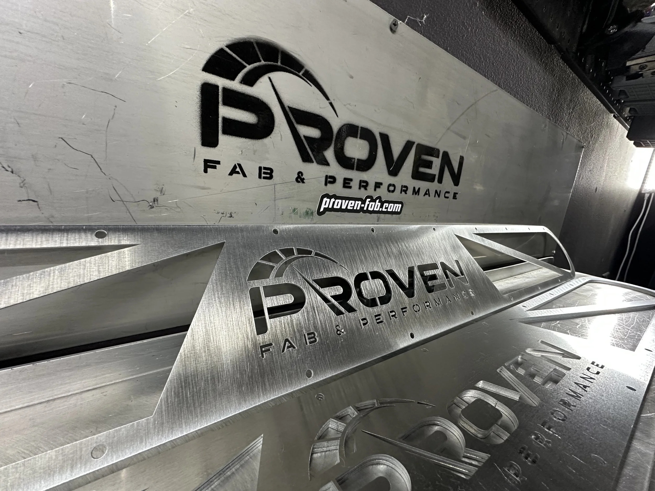 Metal signs display the brand name 'PROVEN' with the words 'FAB & PERFORMANCE' underneath and a website URL 'ptoven-fab.com' at the bottom.