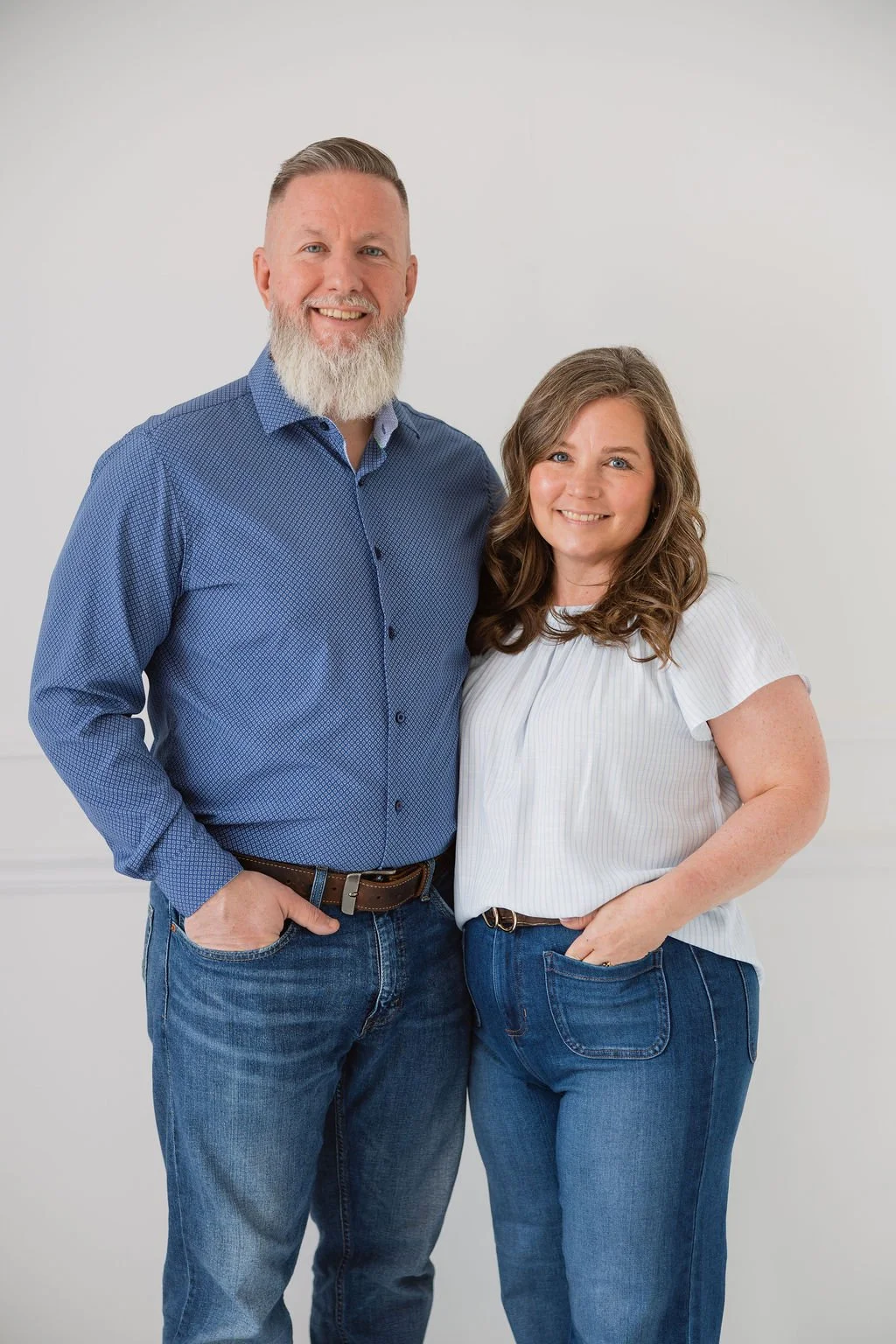 Garr and Jessica Owens of Oikos Home Services standing together for home repair and real estate support in Delaware