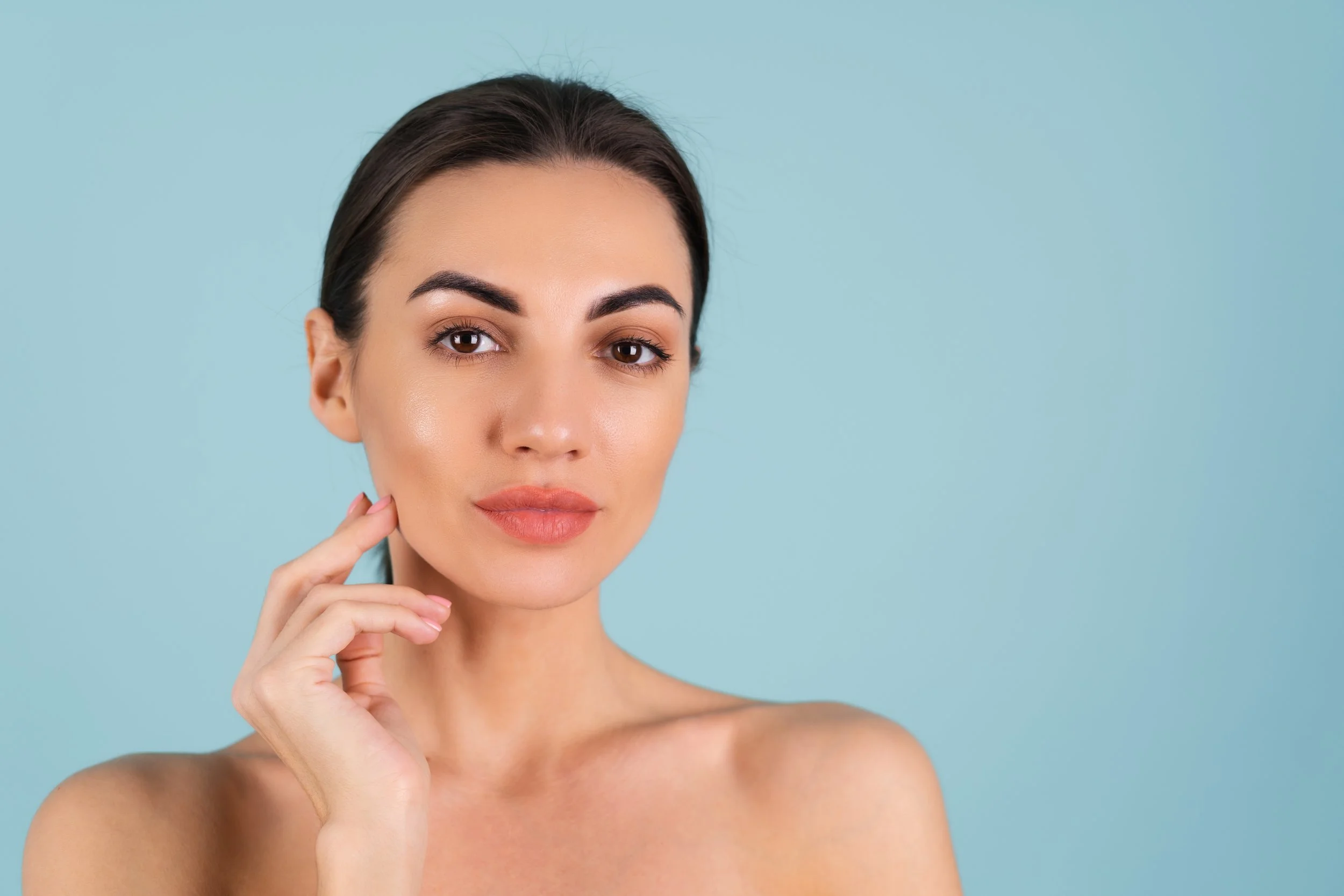 close-beauty-portrait-topless-woman-with-perfect-skin-natural-make-up-plump-nude-lips-blue-background.jpg
