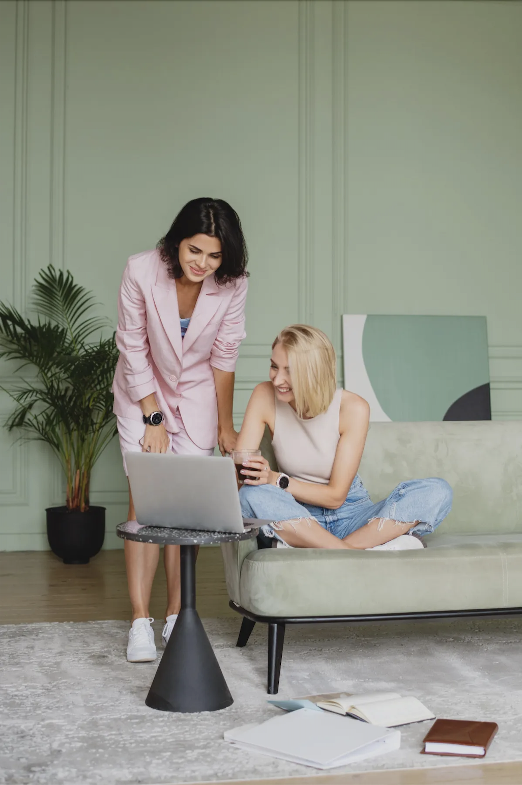 Two freelance creatives reviewing work together on a laptop, representing personalised support and clarity in a freelance business.