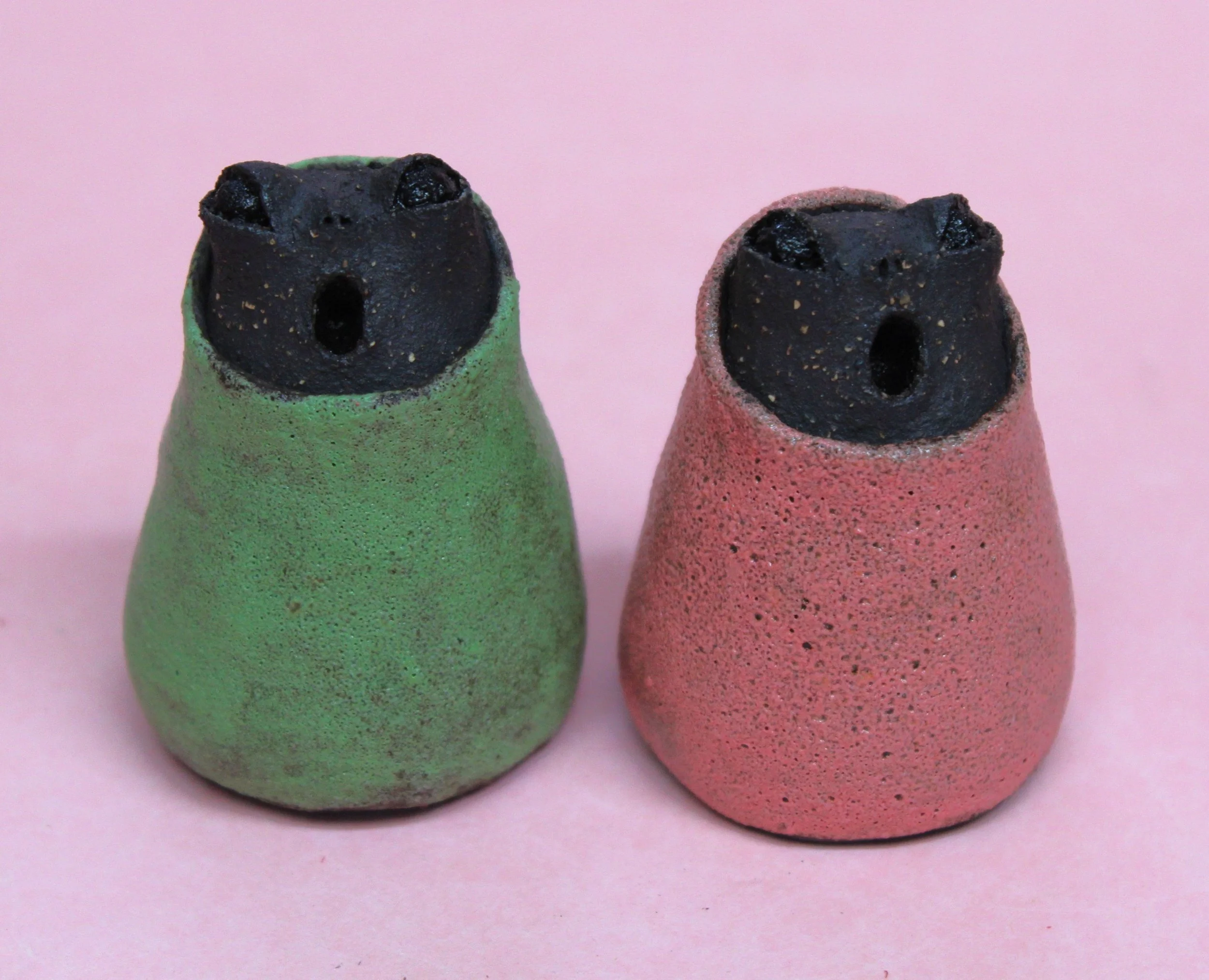 Small Black Creatures in Colourful Outfits