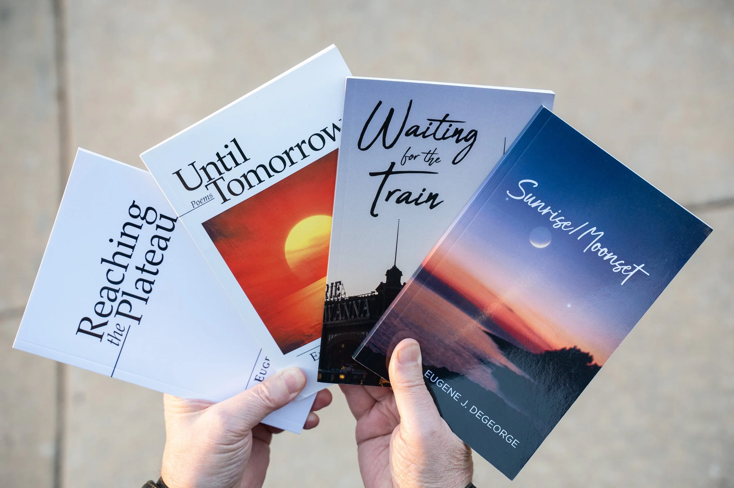 Eugene DeGeorge holds his books in his hands