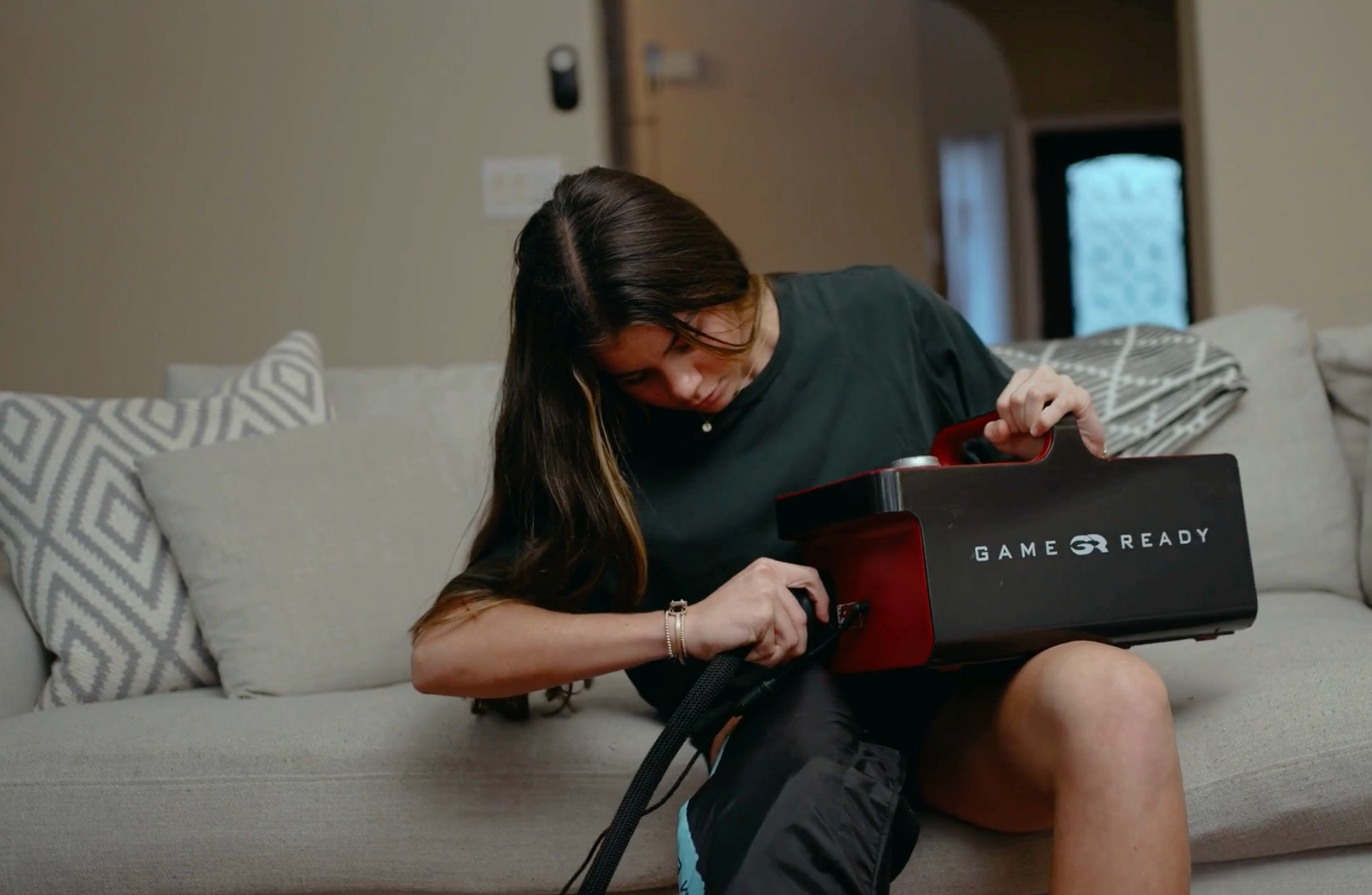 Valor DME specialist delivering a professional-grade Game Ready cold therapy unit to a patient's home in San Antonio for rapid sport injury rehab.