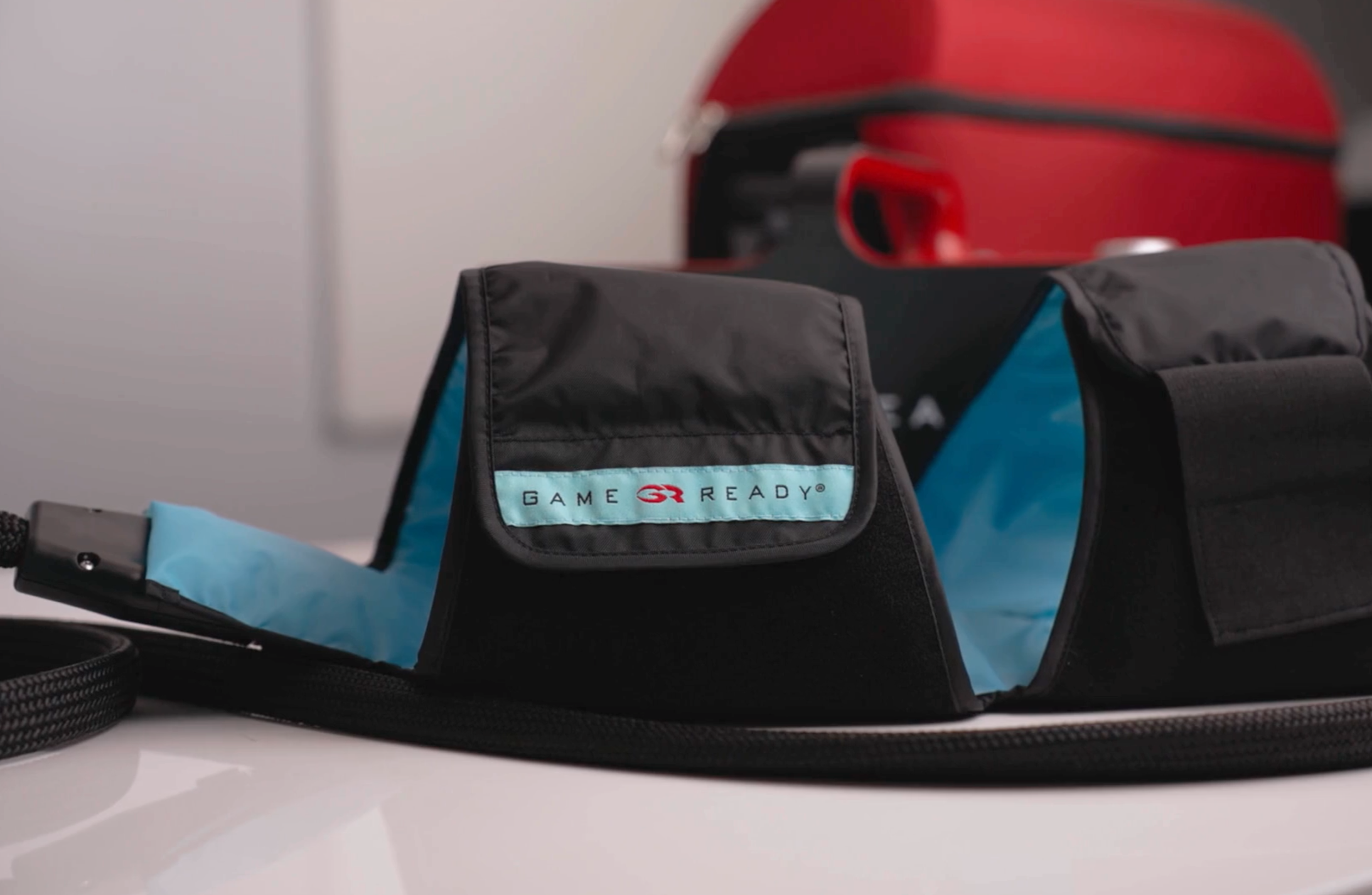 Anatomically designed Game Ready knee wrap providing circumferential cold therapy for a San Antonio soccer player's meniscus tear recovery.