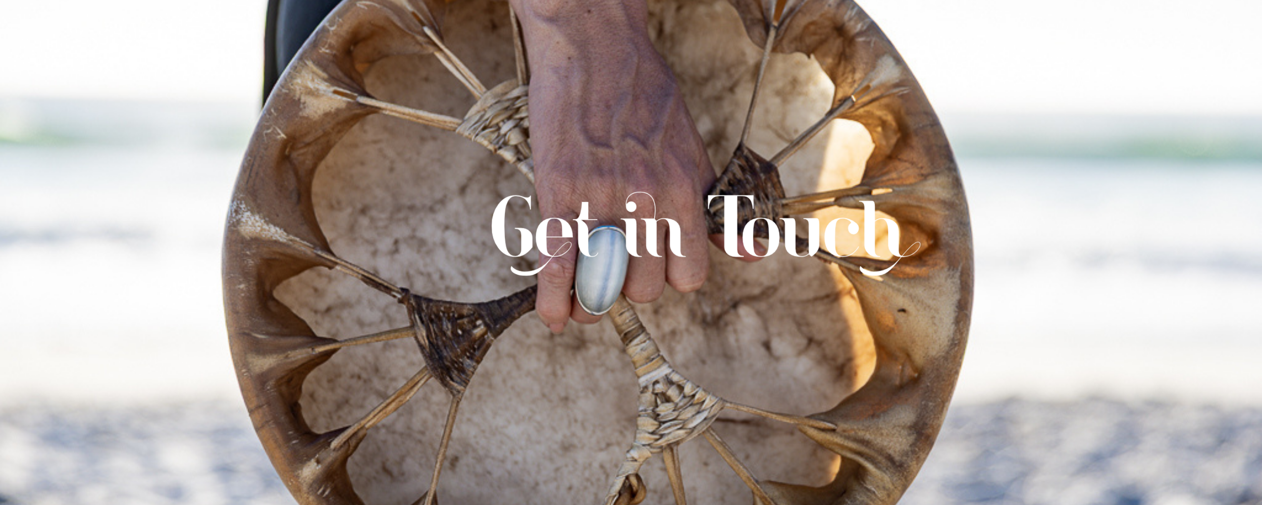 Alrina Laker's hand holding a shamanic drum beater, representing the invitation to reach out and begin your Sacred Ember journey