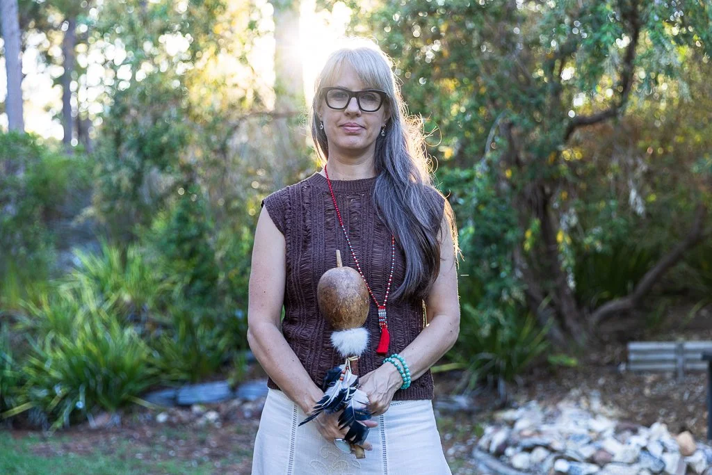 Alrina Laker holding a shamanic gourd rattle, representing her practice of Shamanic Energy Medicine rooted in Andean Q'ero tradition
