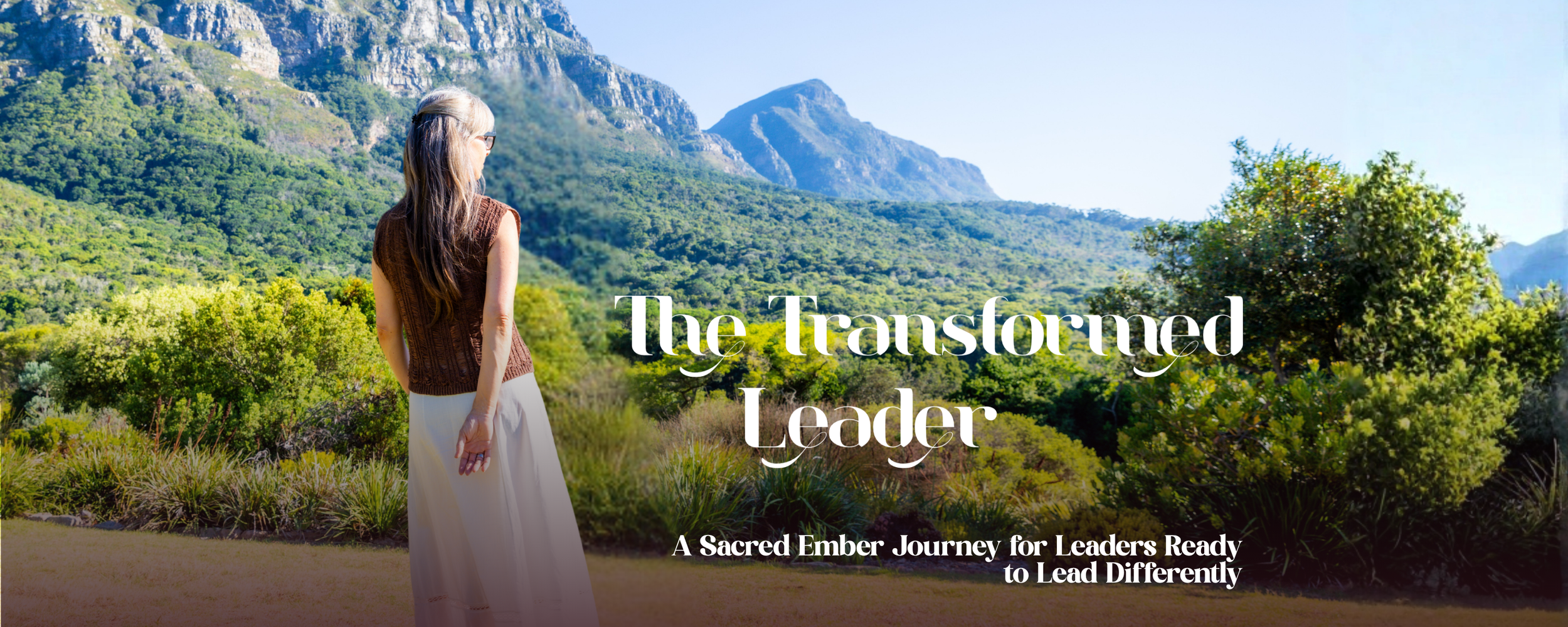 Alrina Laker standing before a mountain landscape in Cape Town, representing The Transformed Leader shamanic leadership journey at Sacred Ember
