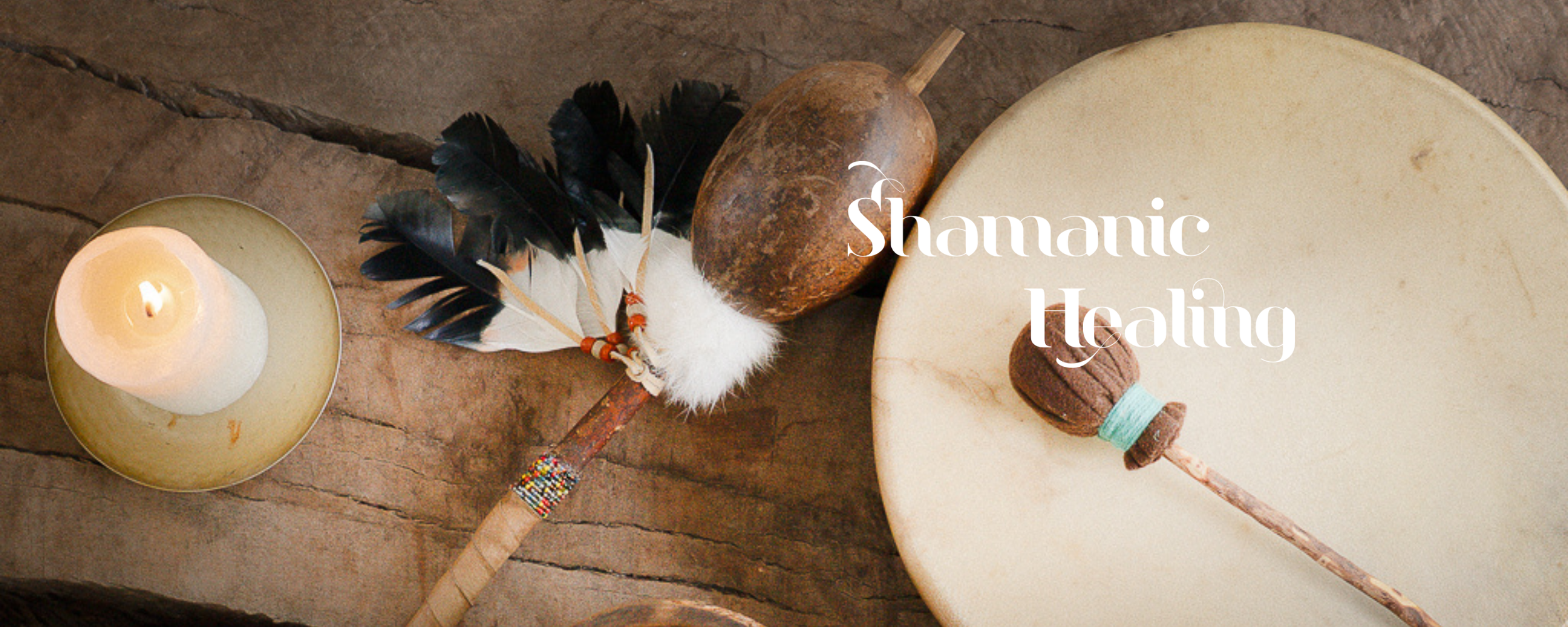Shamanic ceremonial tools including a drum, gourd rattle, feathers, and candle used in Sacred Ember energy medicine sessions