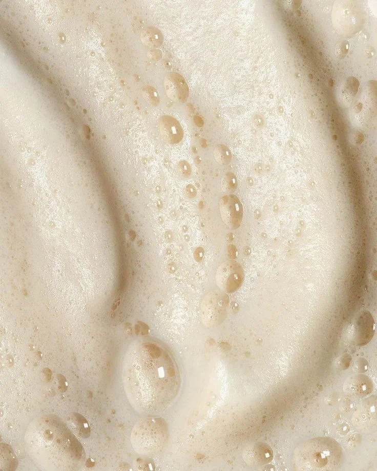 Close-up of frothy, bubbling liquid, likely a creamy beverage or batter.