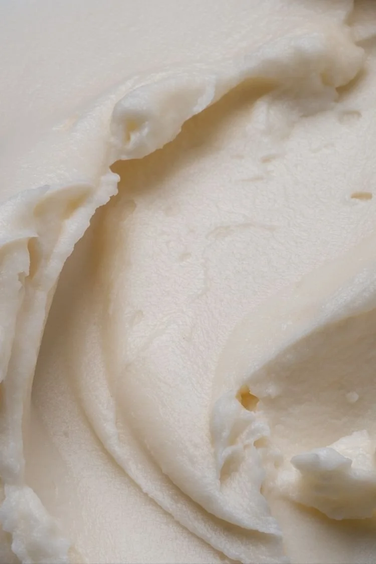 Close-up of smooth, creamy vanilla ice cream with soft swirls.