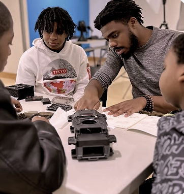 Two teens working on robotics