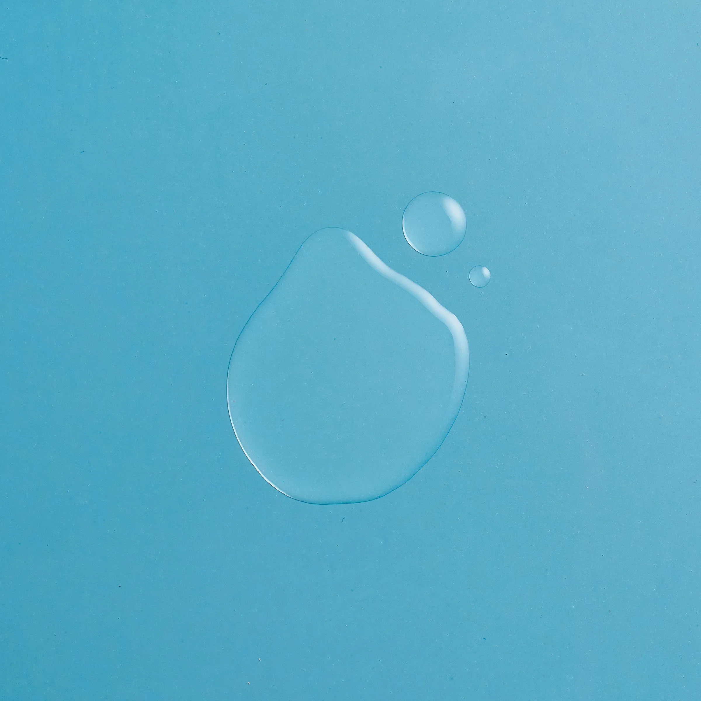 Close-up of a few water droplets on a light blue surface. Chicago Milwaukee Midwest Illinois Food Food beverage Food Drink Savory Photographers photographer photography videography videographer CPG Bennett Fuhrman Ben Tiny Scheme