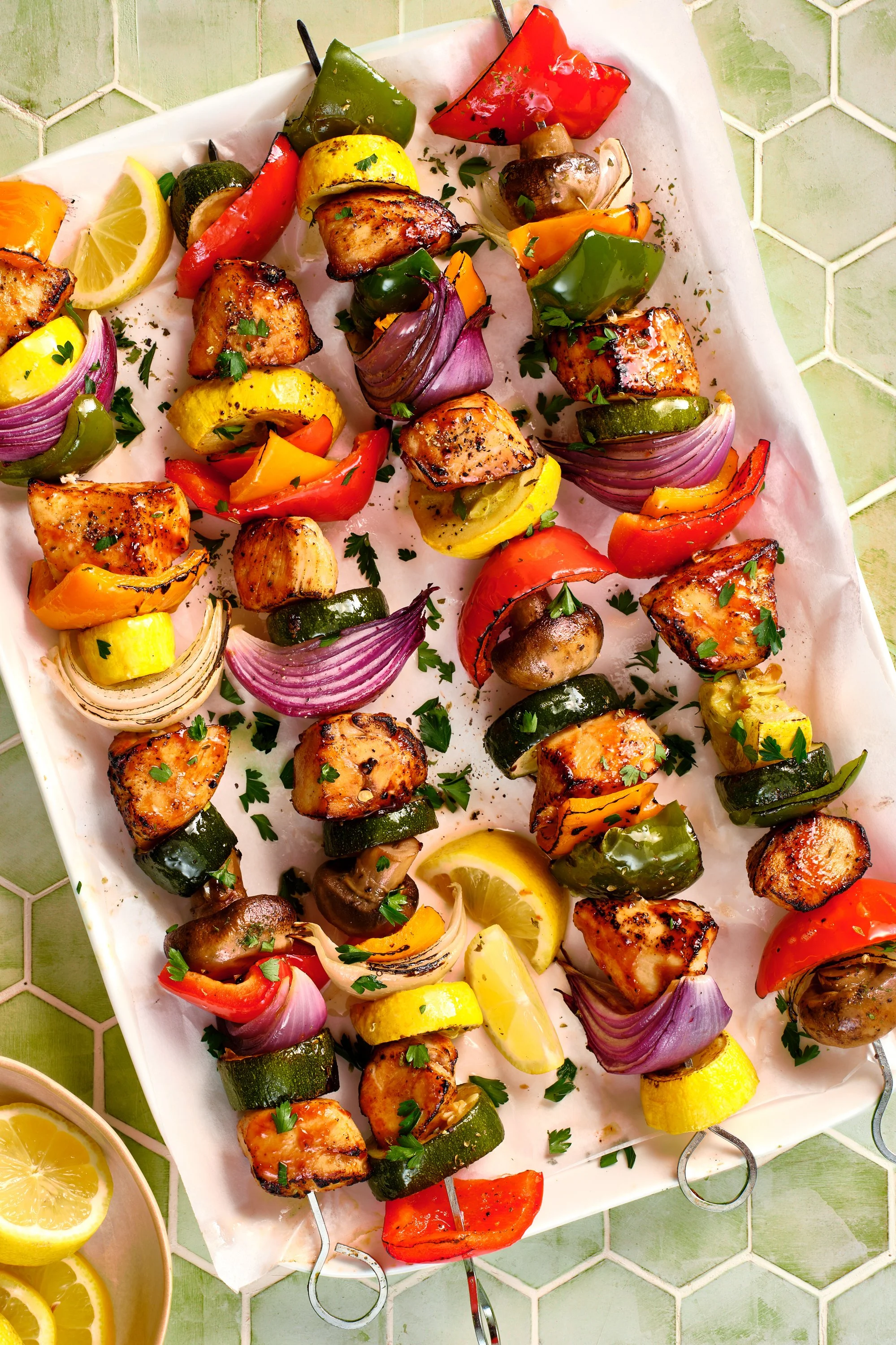 Colorful grilled vegetable skewers with zucchini, red and green bell peppers, onions, cherry tomatoes, and mushrooms on a white platter. Chicago Milwaukee Midwest Illinois Food Food beverage Food Drink Savory Photographers photographer photography vi