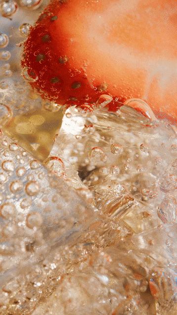 Close-up of a strawberry submerged in bubbly carbonated water. Chicago Milwaukee Midwest Illinois Food Food beverage Food Drink Savory Photographers photographer photography videography videographer CPG Bennett Fuhrman Ben Tiny Scheme