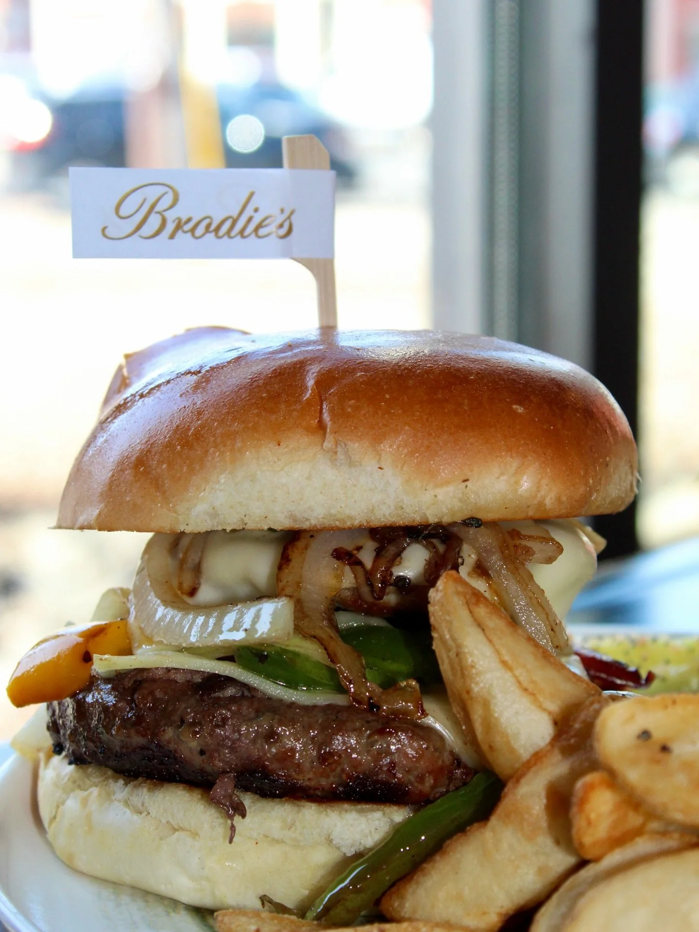 Burger piled high&mdash;just like your weekend plans 

Sausage stacked on a juicy patty, loaded with peppers, onions, and melted provolone. Saturday done right. Plan your visit at brodiespeabody.com