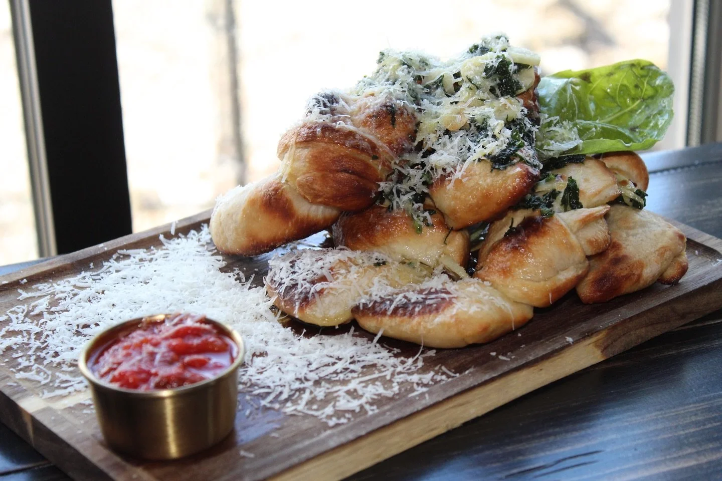 New menu item reveal! 

These are guaranteed to satisfy every craving.

Garlic knots twisted and tied in house, baked to perfection, finished with parmesan, and served with our homemade marinara for dipping
