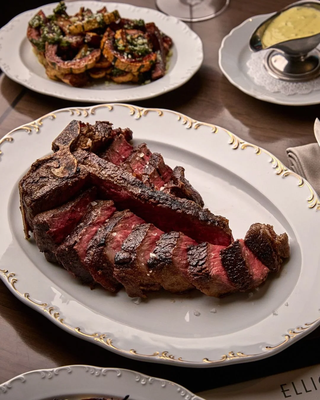 Wood-fired Bistecca Fiorentina paired with our classic, rich B&eacute;arnaise sauce.