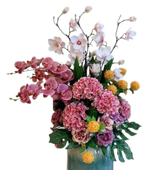 Arrangement of pink, white, and yellow flowers in a vase