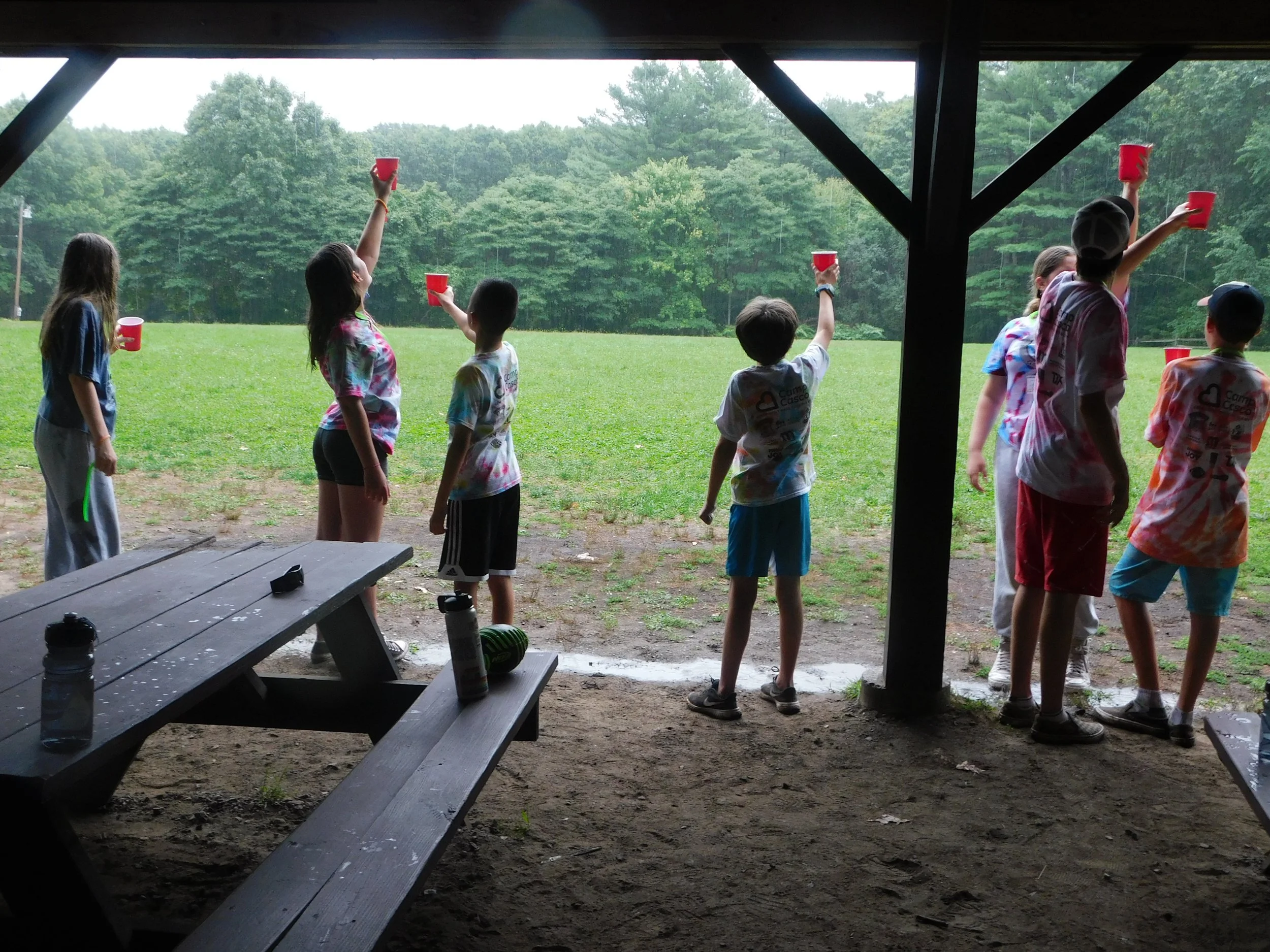 Campers raising their cups in celebration