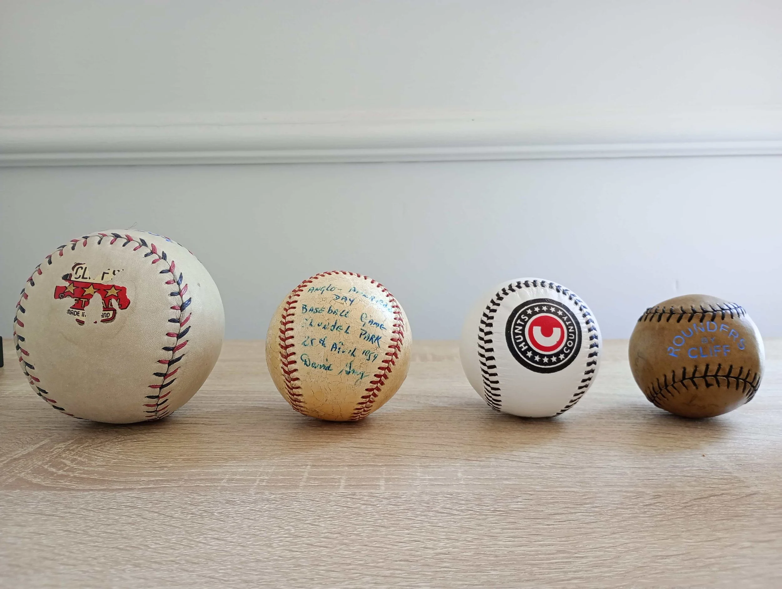 Jabez Cliff softball, national league baseball, Hunts County ball for Welsh Baseball, and Jabez Cliff rounders ball. Author's own collection.