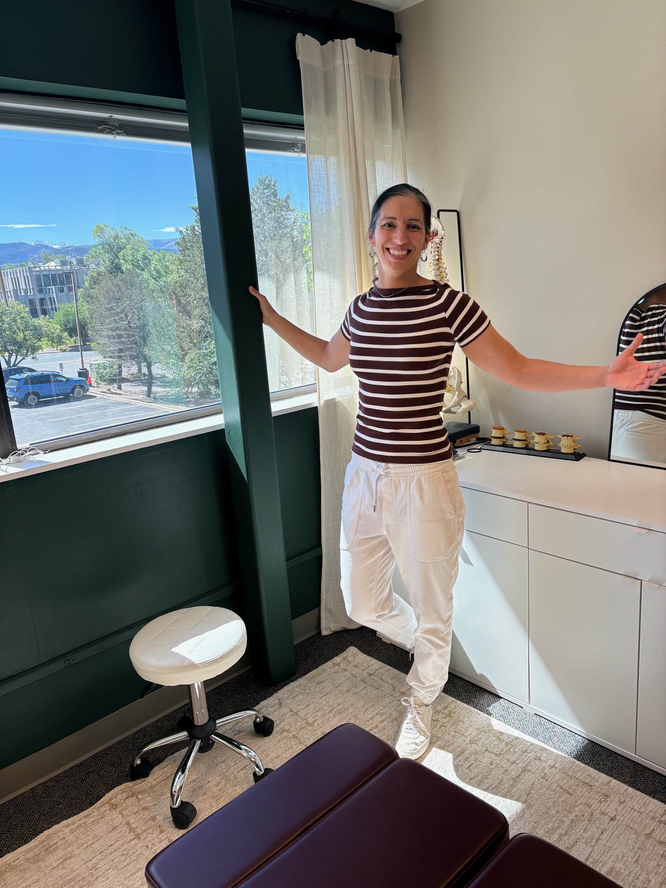 Dr. Leslie in a welcoming consultation room at Destination Chiropractic in Boulder