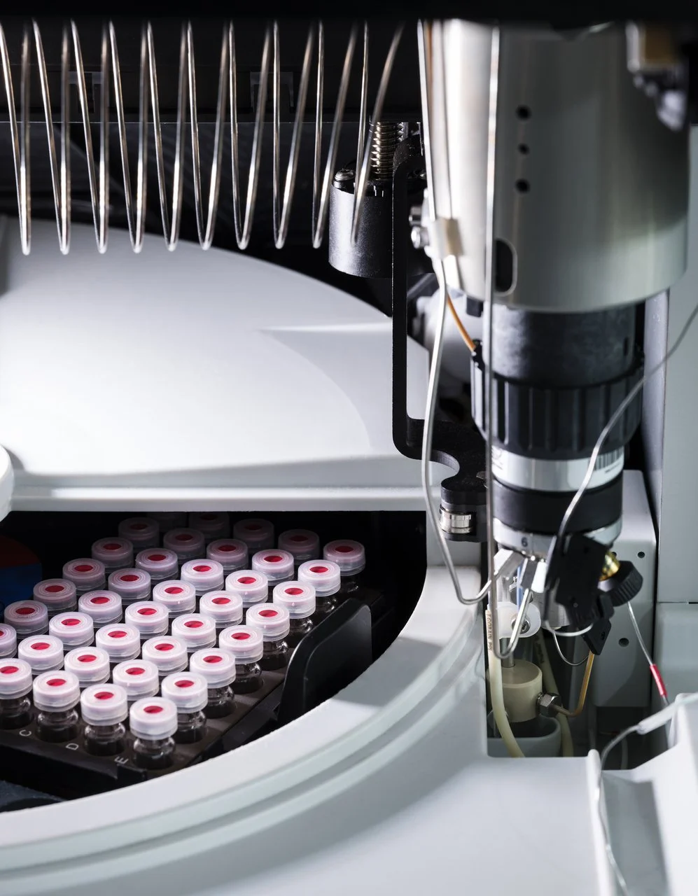 A laboratory centrifuge machine with multiple test tubes filled with blood or plasma, ready for analysis.