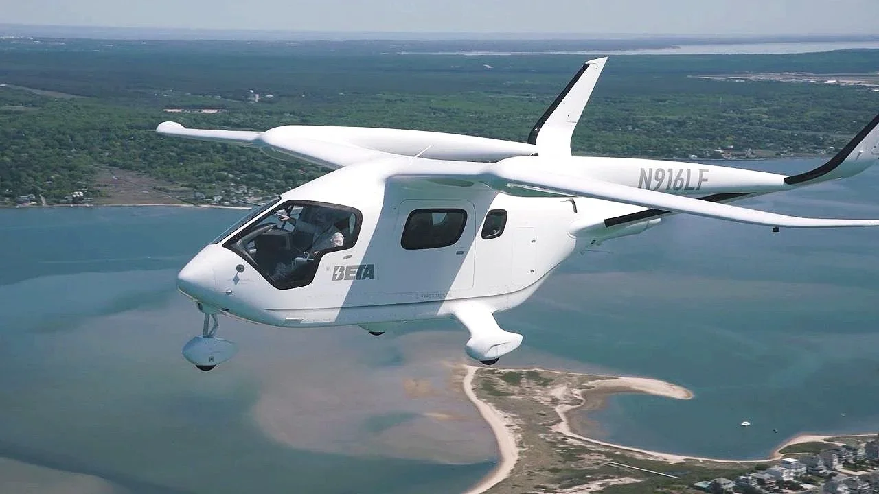 White Beta Technologies Alia Electric plane flying over the coastline.