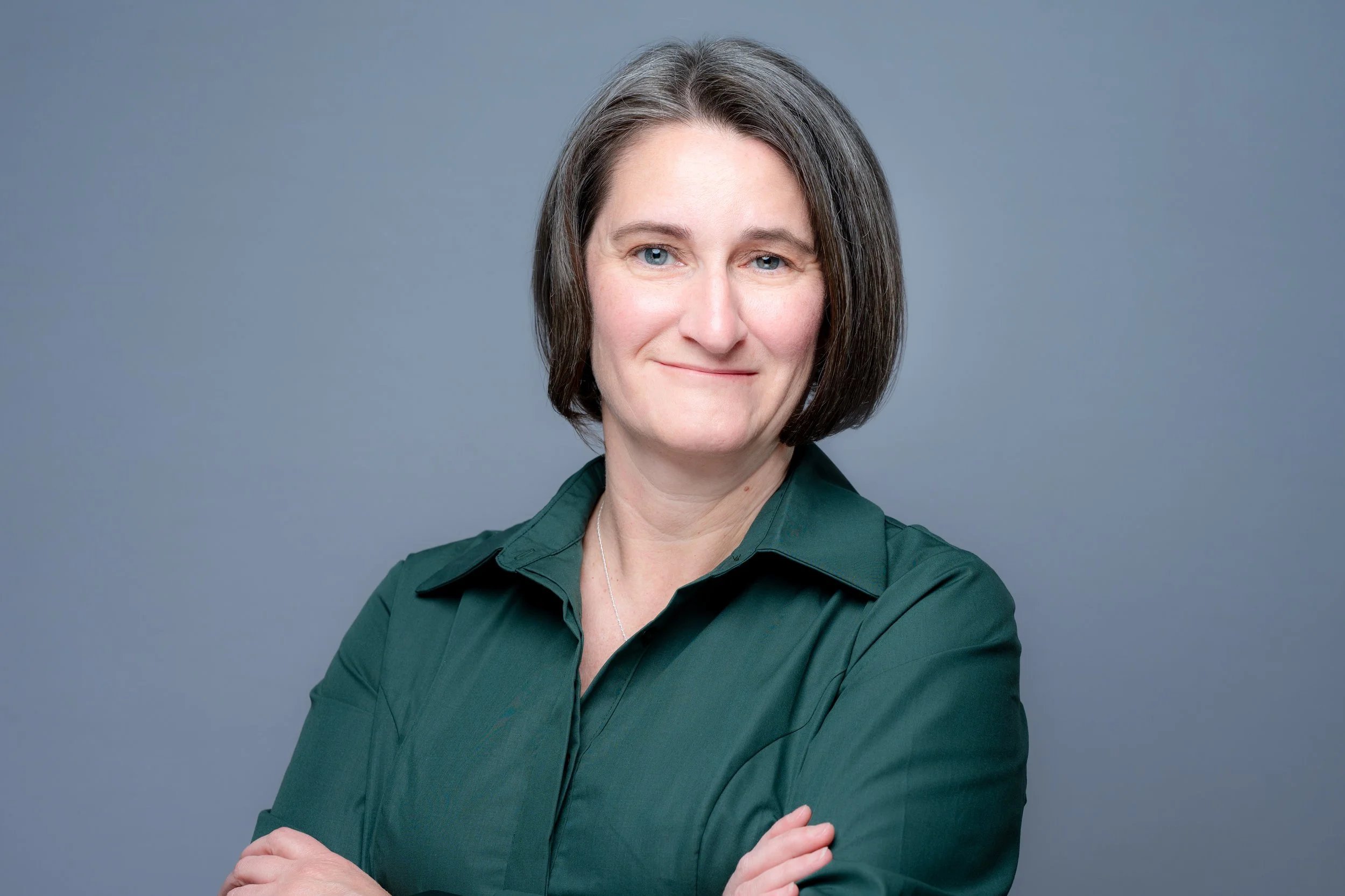 Woman headshot short hair green dress
